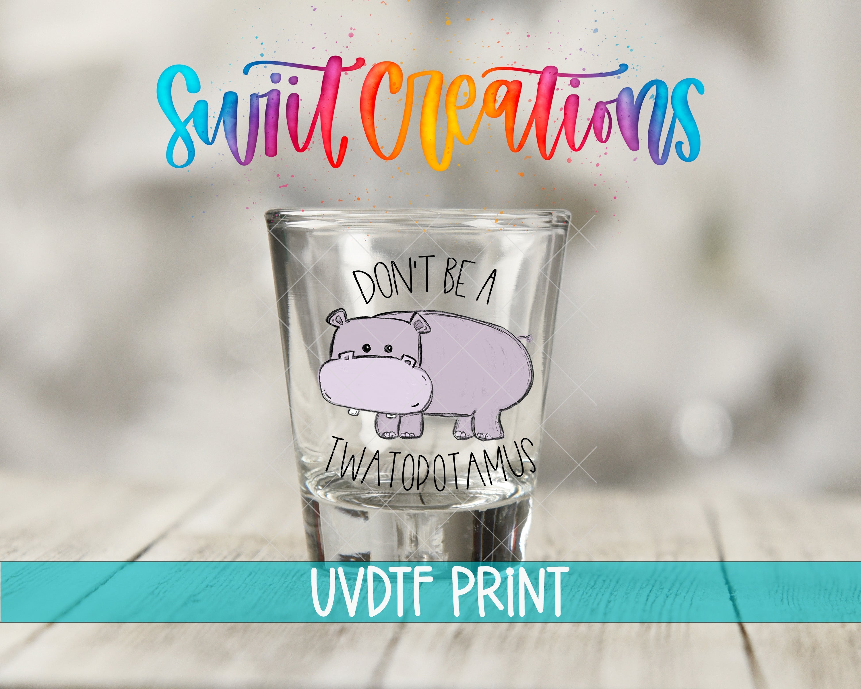 a shot glass with a drawing of a hippo on it