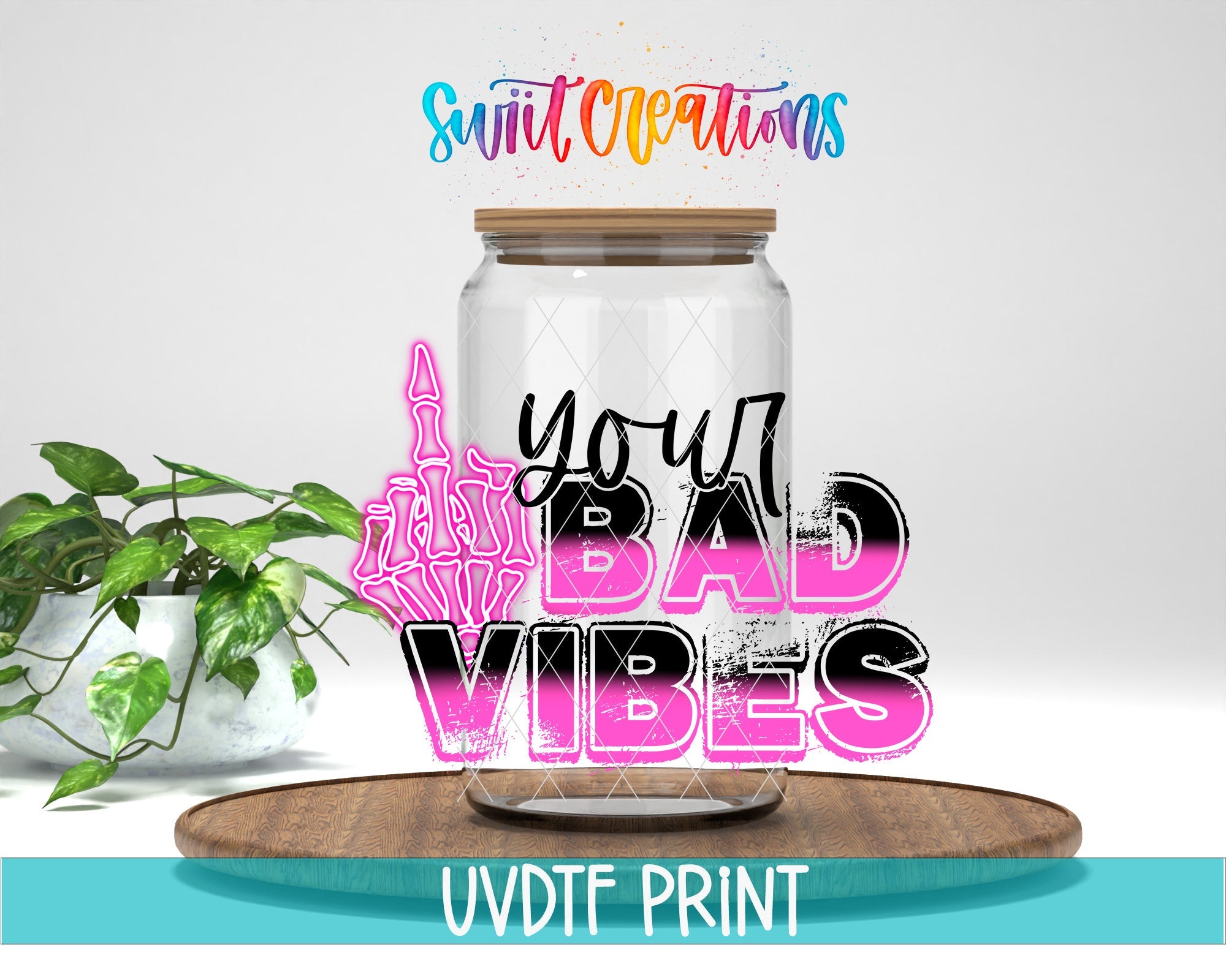 a jar filled with graffiti and a plant on top of a table