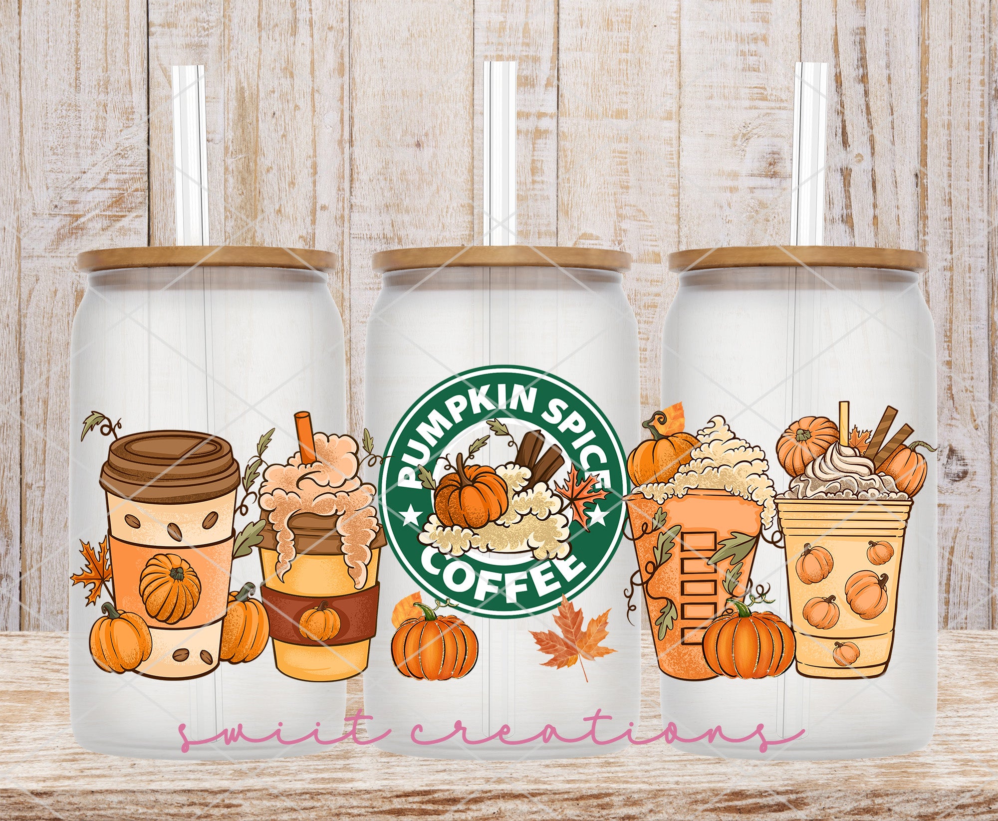 a couple of starbucks cups sitting on top of a wooden table