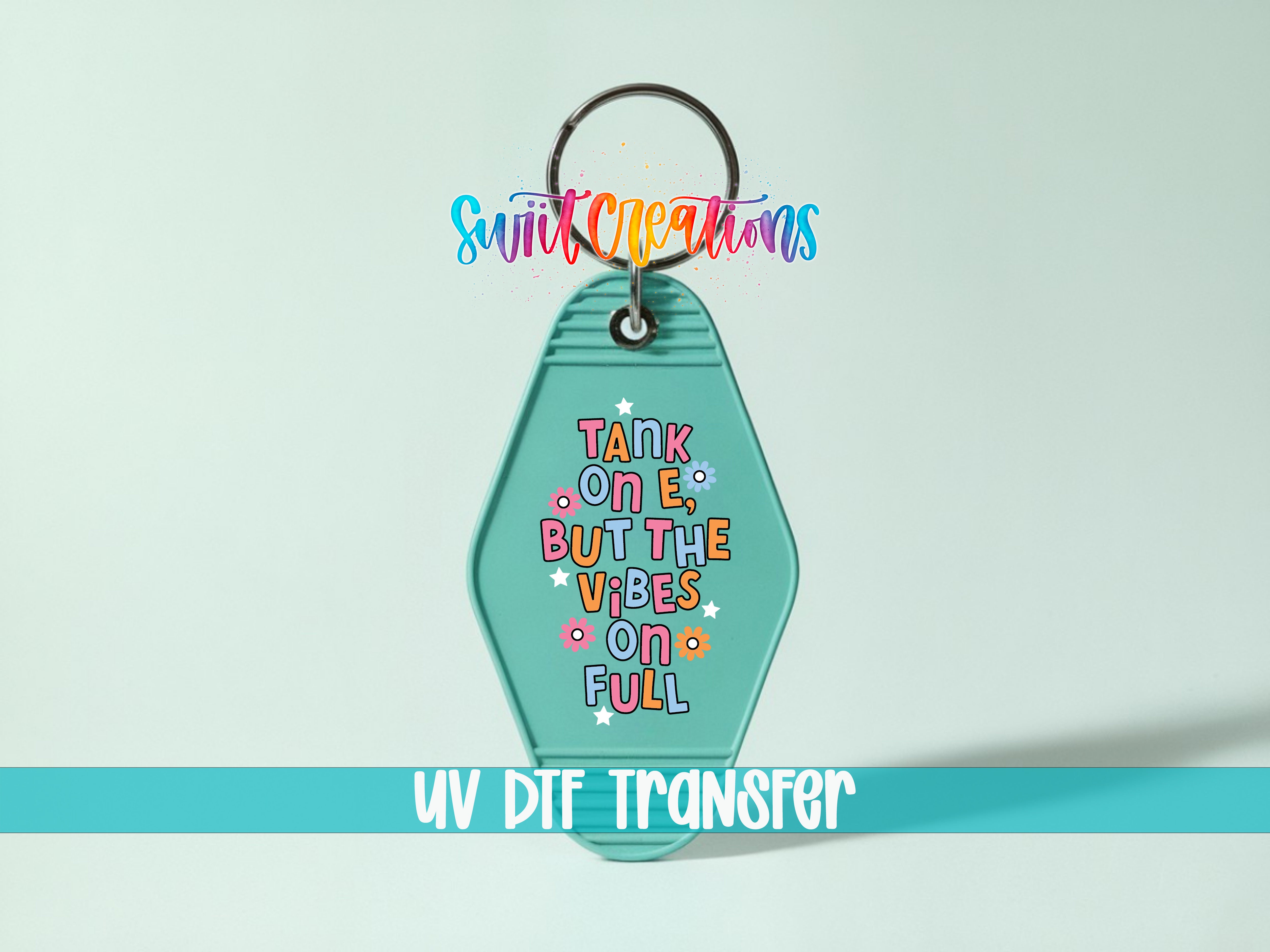 A keychain with a colorful design and text on it, along with a UV DIF Transfer label below it.