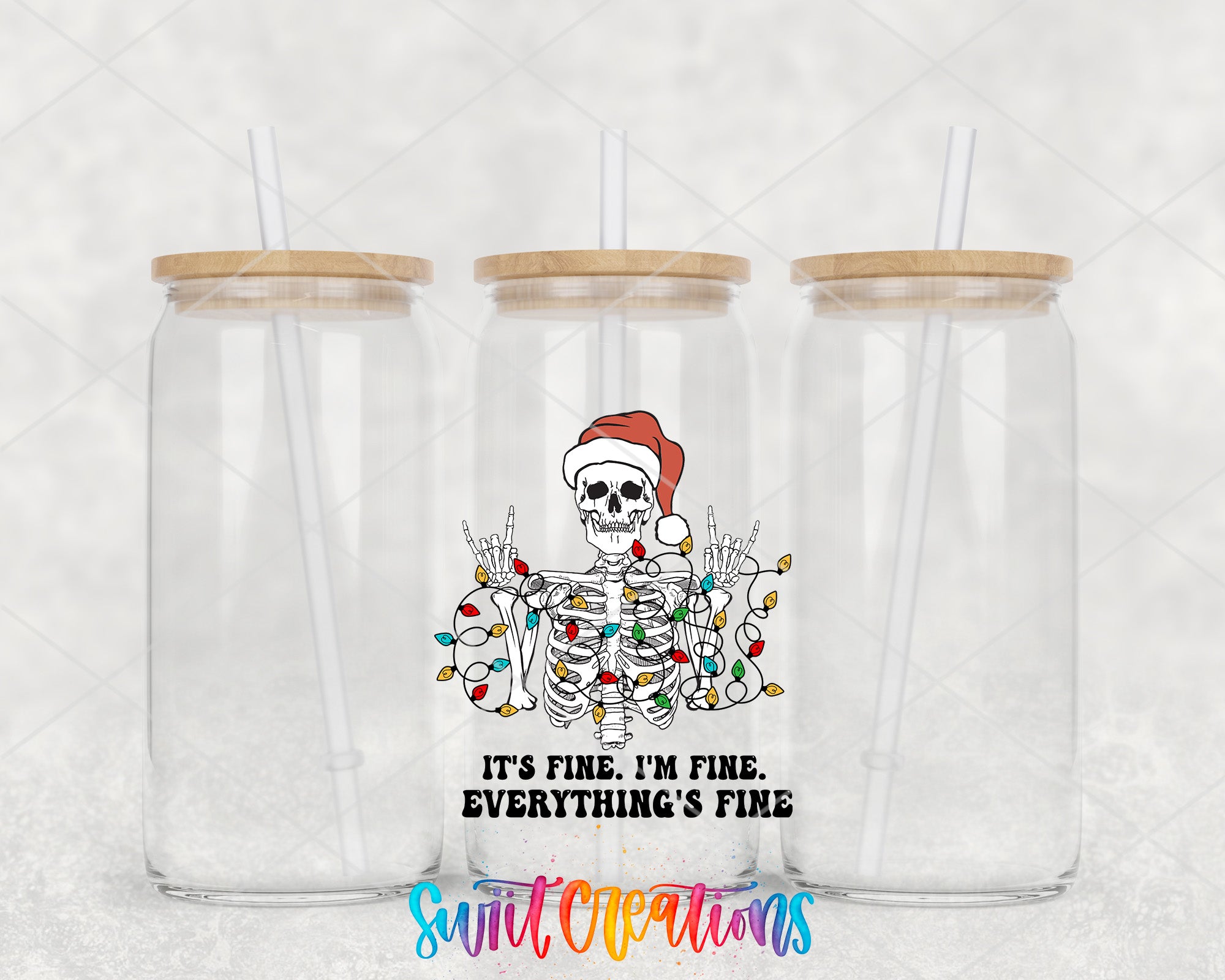 two clear tumblers with a skeleton on the front and a santa hat on the