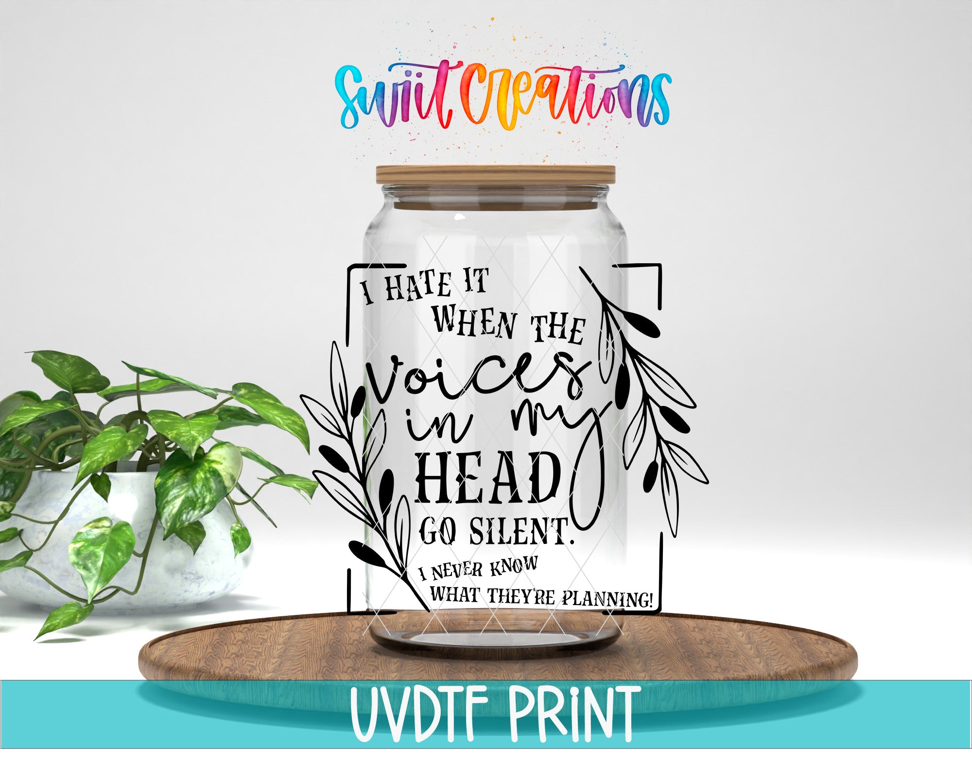 a glass jar with a saying on it next to a potted plant