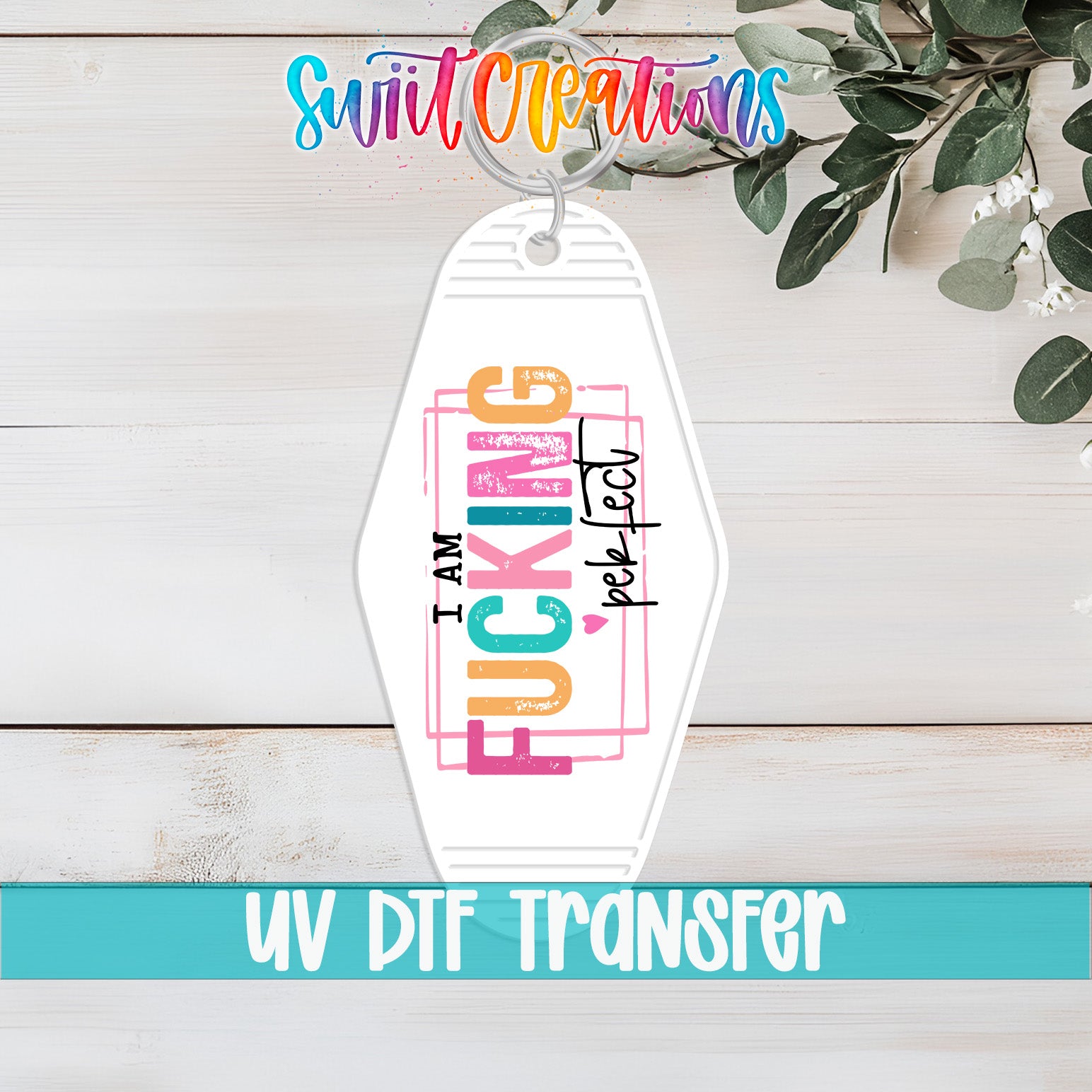 A keychain with the text "I AM FUCKING PERFECT" printed on it, along with a UV DFT Transfer logo.