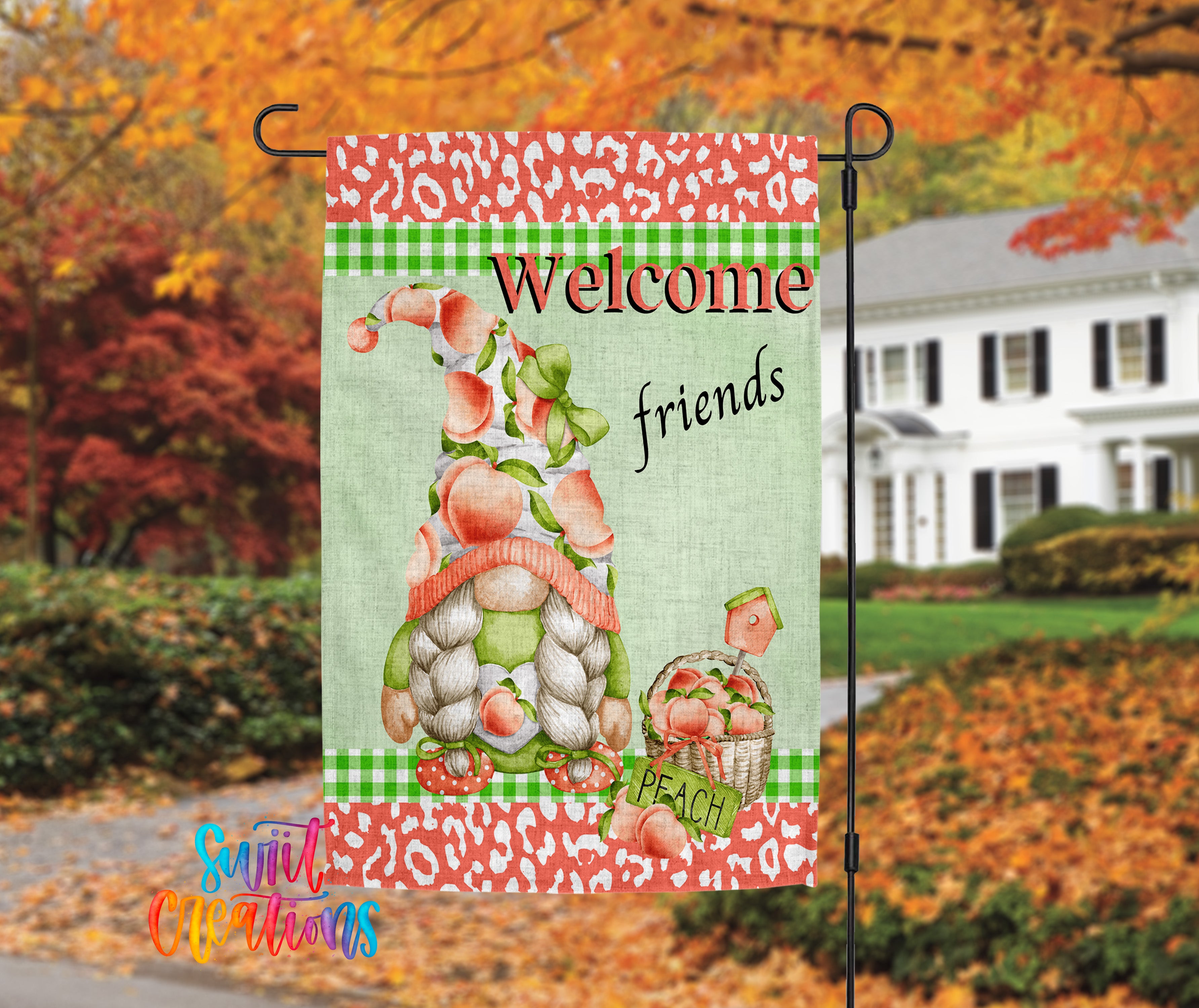 A colorful welcome sign featuring a gnome holding a basket of peaches, set against a backdrop of autumn foliage and a white house.