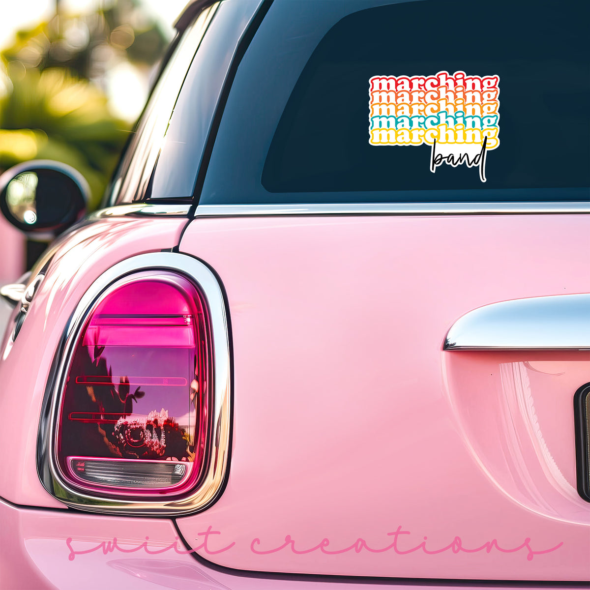 Retro Marching Band sticker on the back window of a pink car