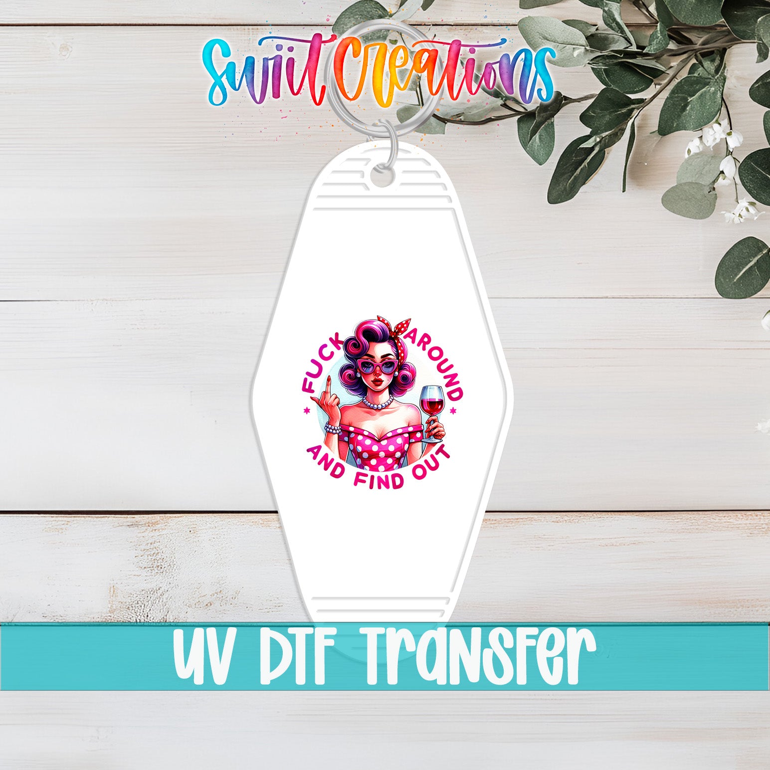 A keychain with a graphic design featuring a woman with curly hair and a pink dress, along with the text "FUCK PAROUN" and "AND FIND OUT".