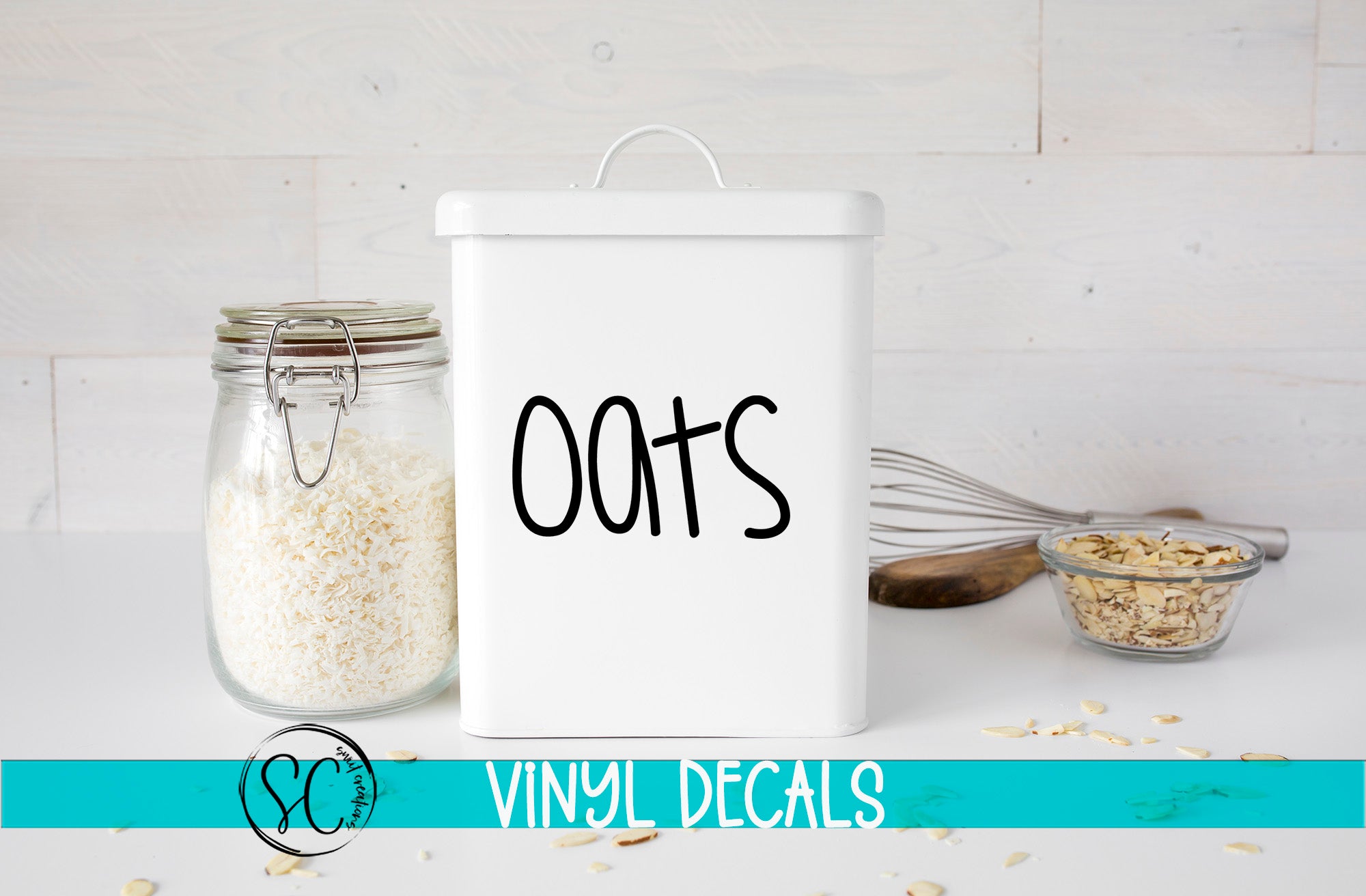 a white container labeled "OATS", a glass jar filled with white rice, and a glass bowl containing nuts, all placed on a white surface.