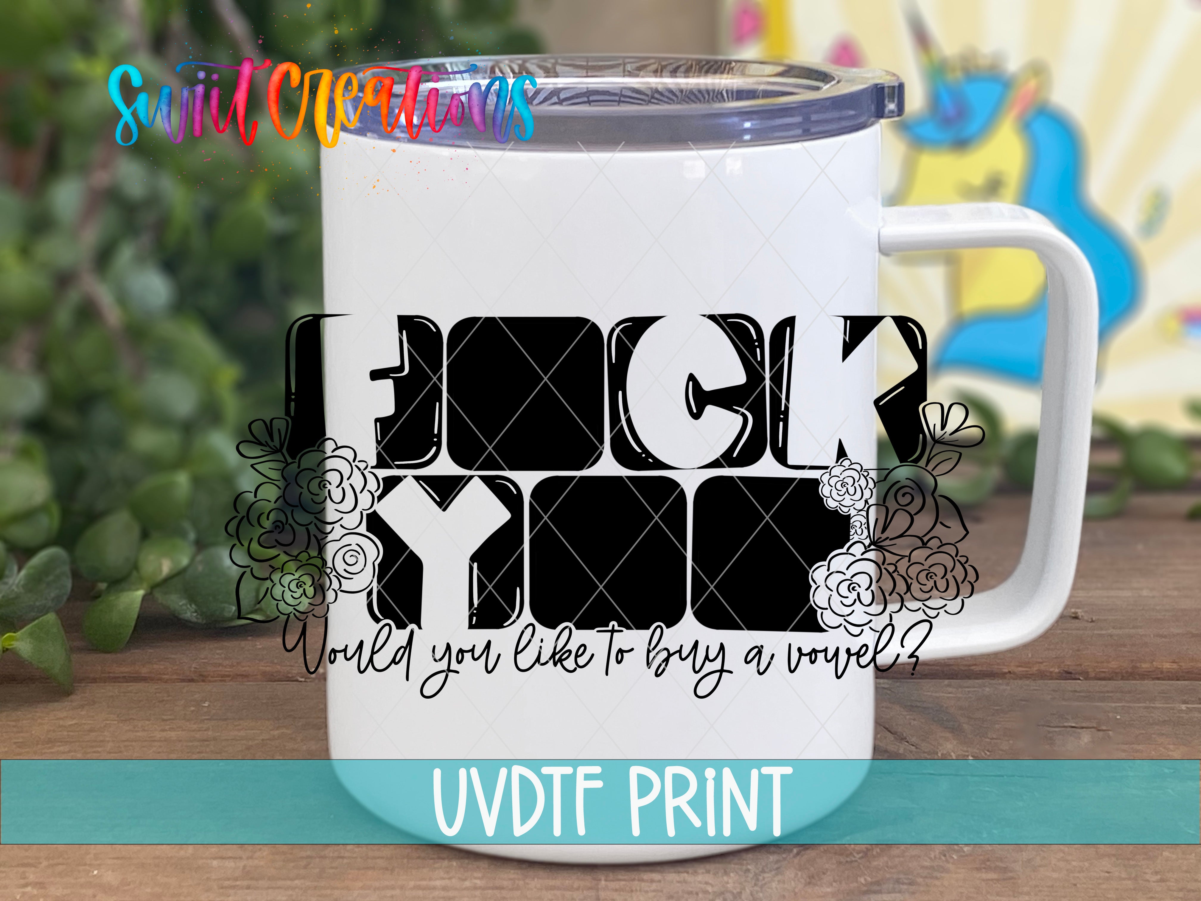 A white mug with a black and white graphic design featuring the word "FUCK YOU" and floral elements.