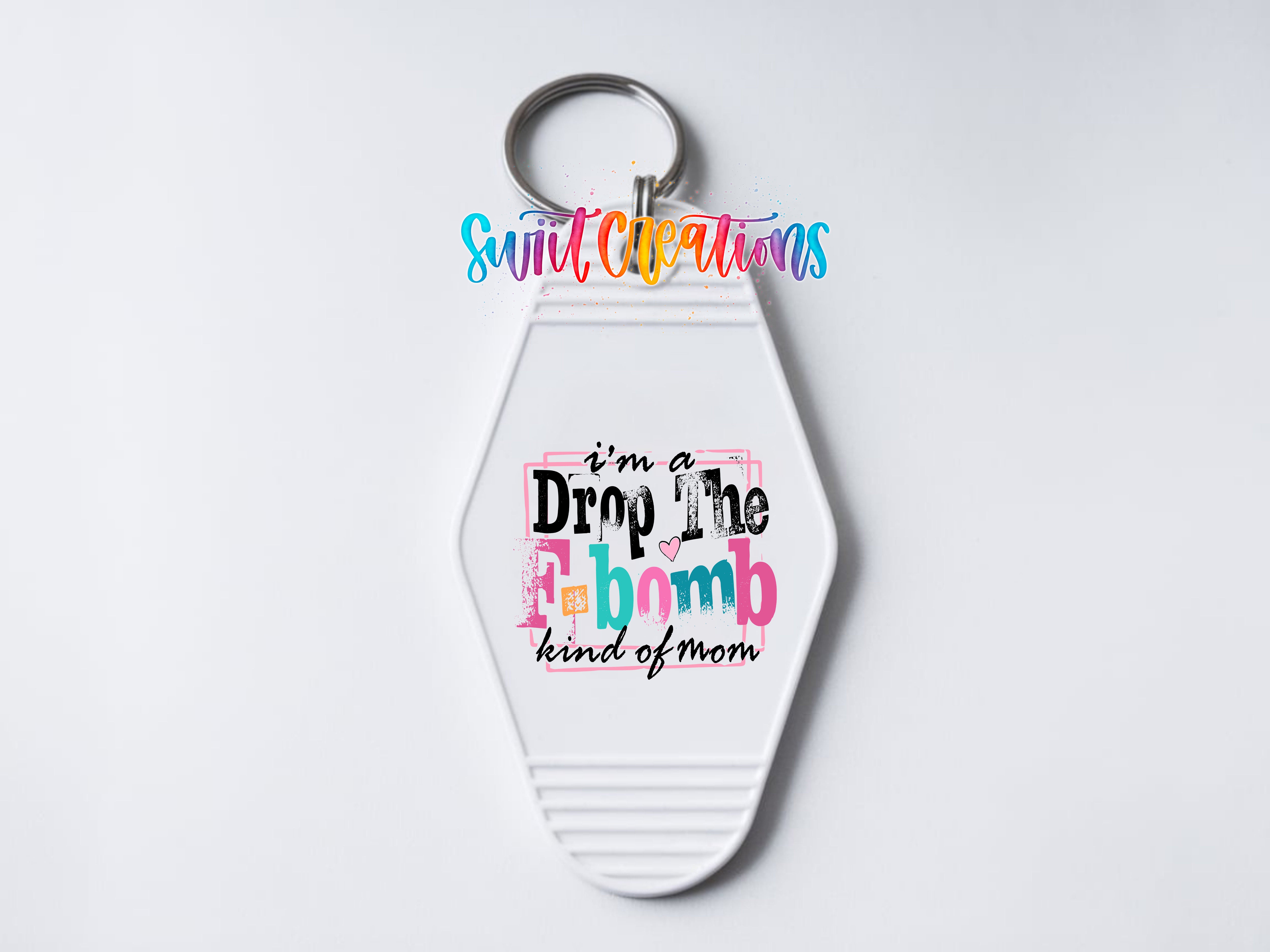 A keychain with a colorful, hand-lettered phrase that reads "I'm a Drop the Bomb kind of Mom" on it.