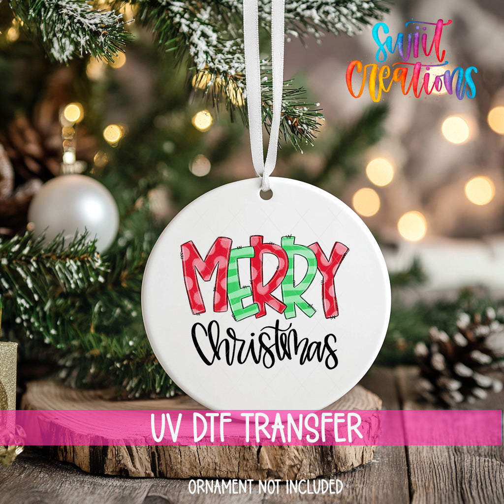 A white Christmas ornament with the text "MERRY CHRISTMAS" printed on it, hanging on a decorated Christmas tree.