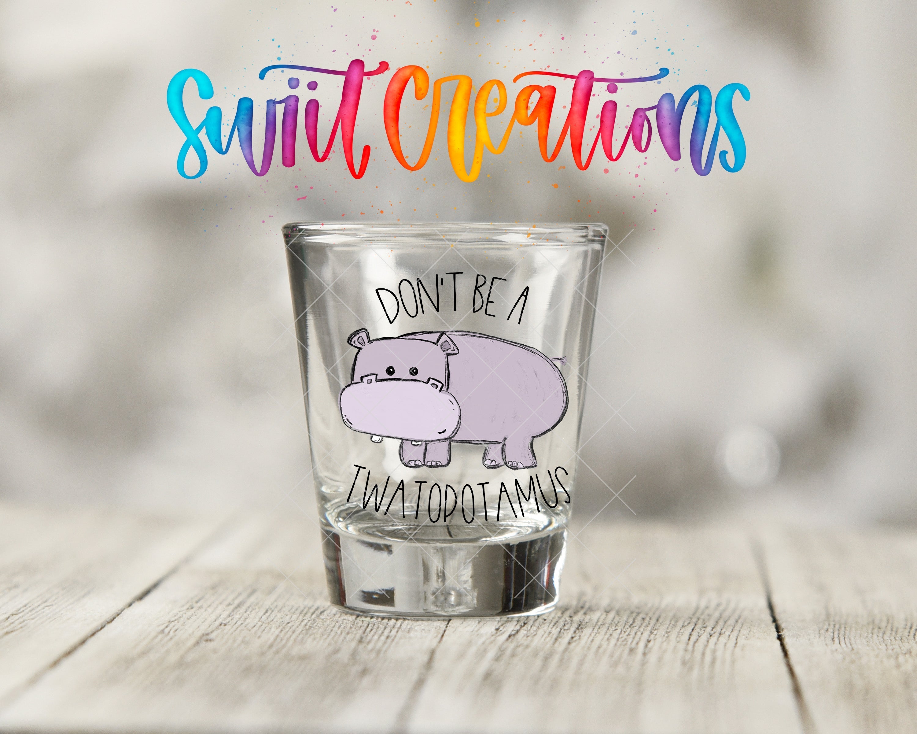 a shot glass with a drawing of a hippo on it
