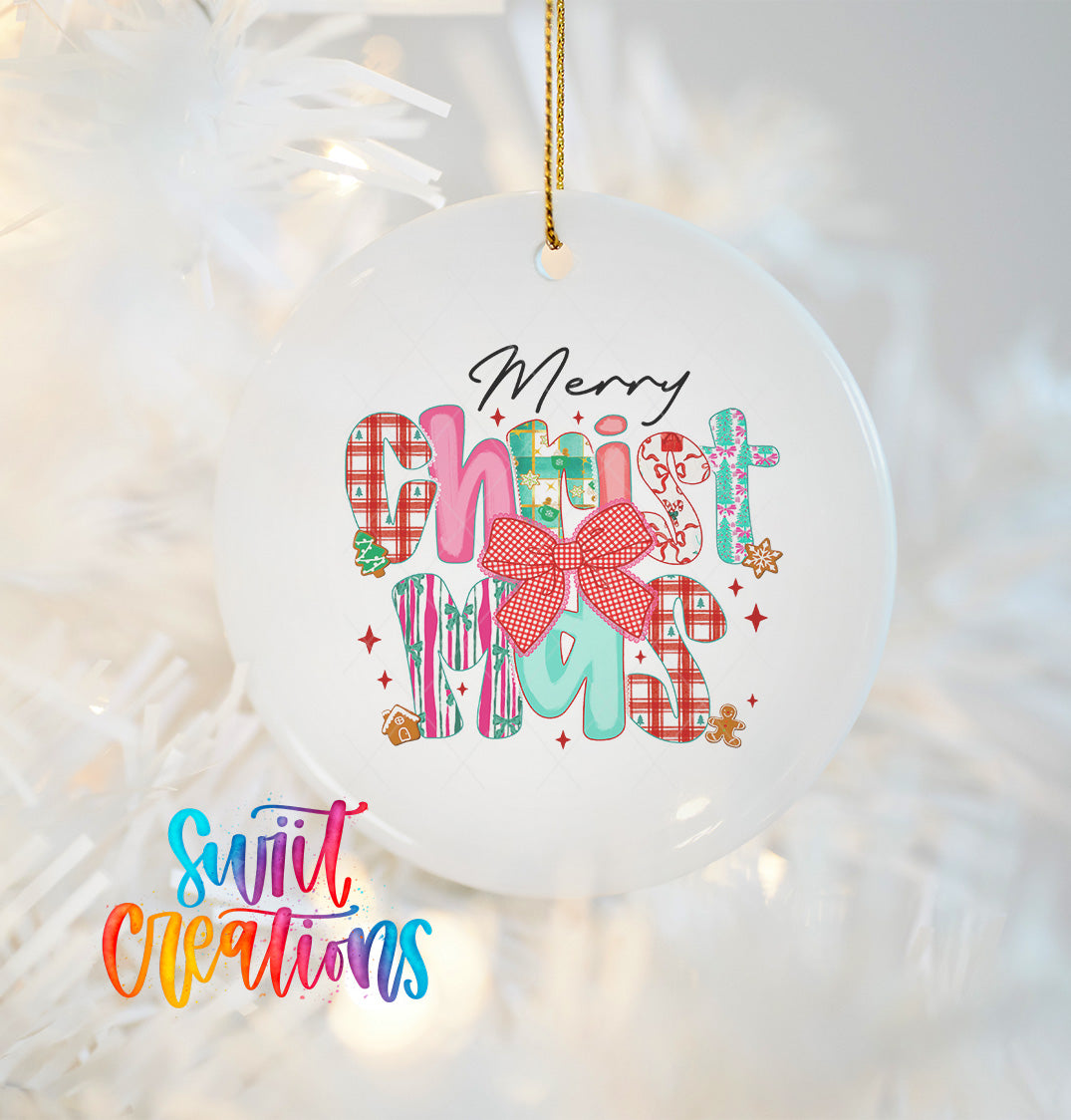 A white Christmas ornament with colorful text and decorations hanging on a string.