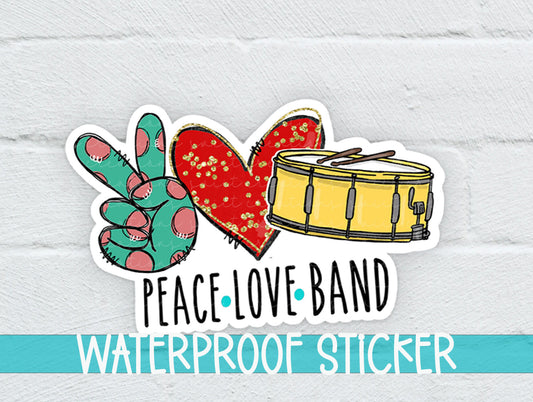 a peace love band sticker on a white brick wall