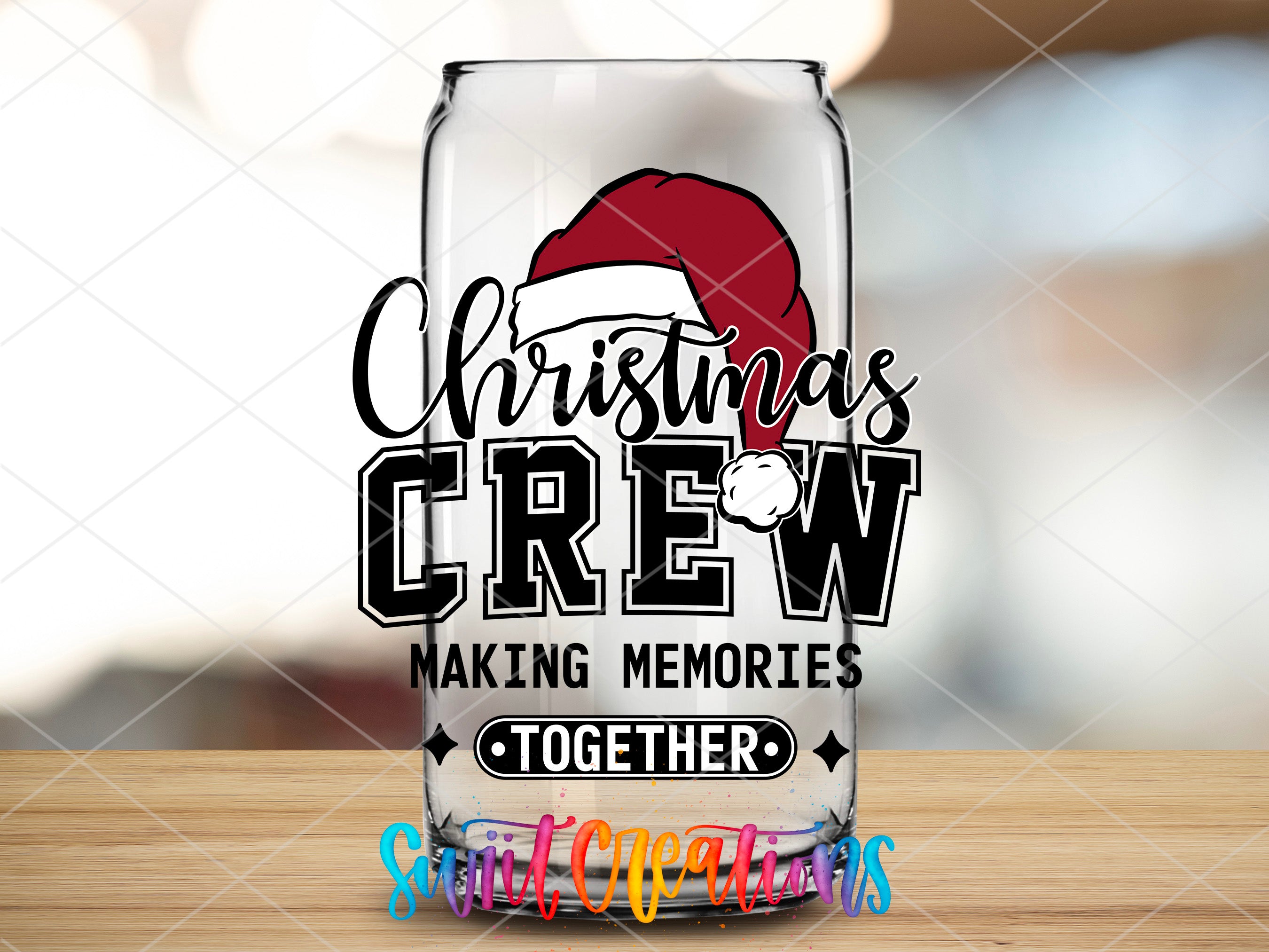 a glass with a santa hat on it sitting on a table