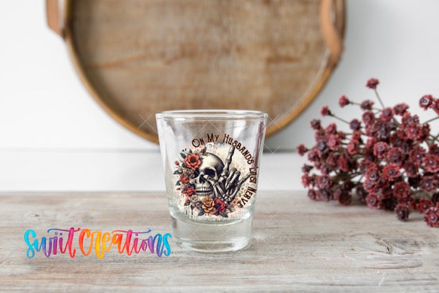 a shot glass sitting on top of a wooden table