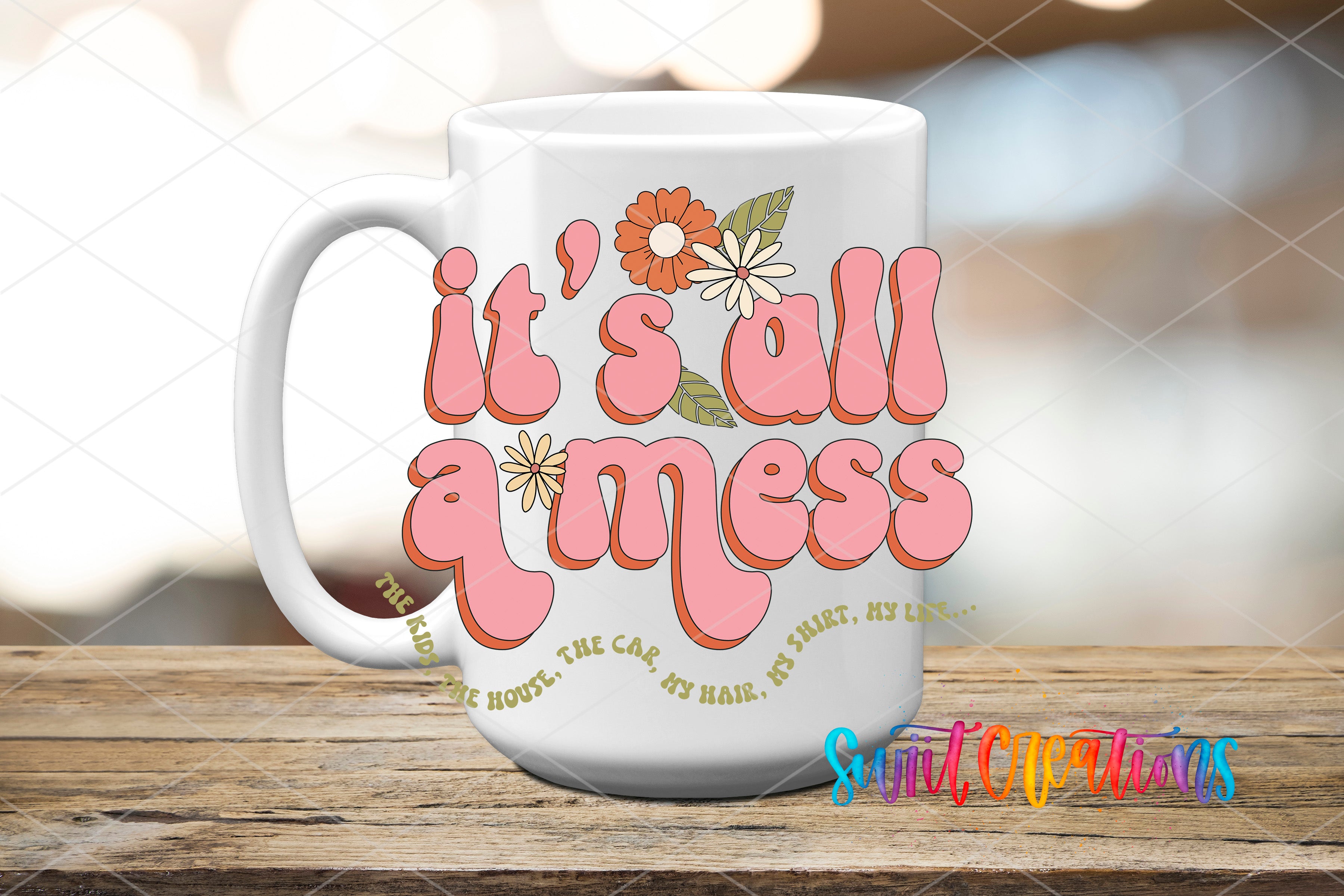 A white mug with a floral design and text printed on it, placed on a wooden surface.