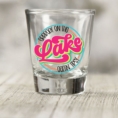 Everybody on the Lake Gettin Tipsy shot glass UV DTF transfer with retro script inside a circle on a clear shot glass