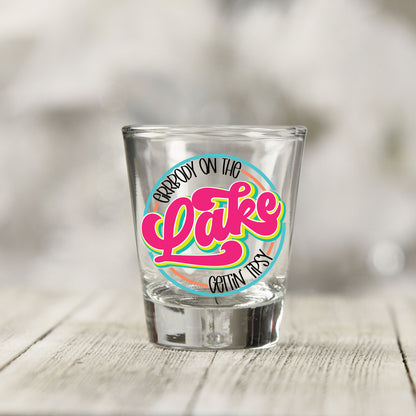 Close-up of the Everybody on the Lake Gettin Tipsy UV DTF transfer on a clear shot glass