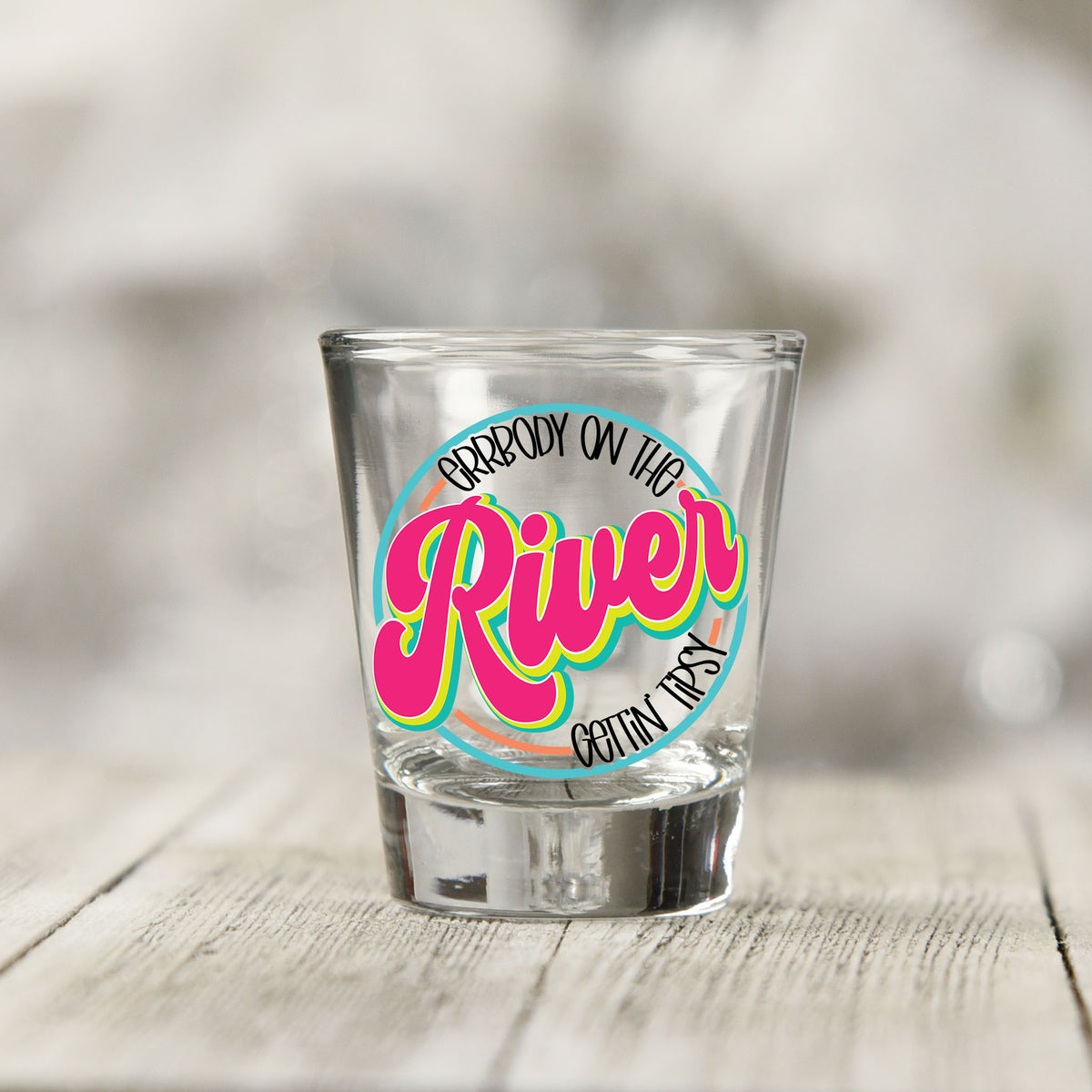 Close-up of the Everybody on the River Gettin Tipsy UV DTF transfer on a clear shot glass