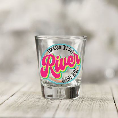 Close-up of the Everybody on the River Gettin Tipsy UV DTF transfer on a clear shot glass