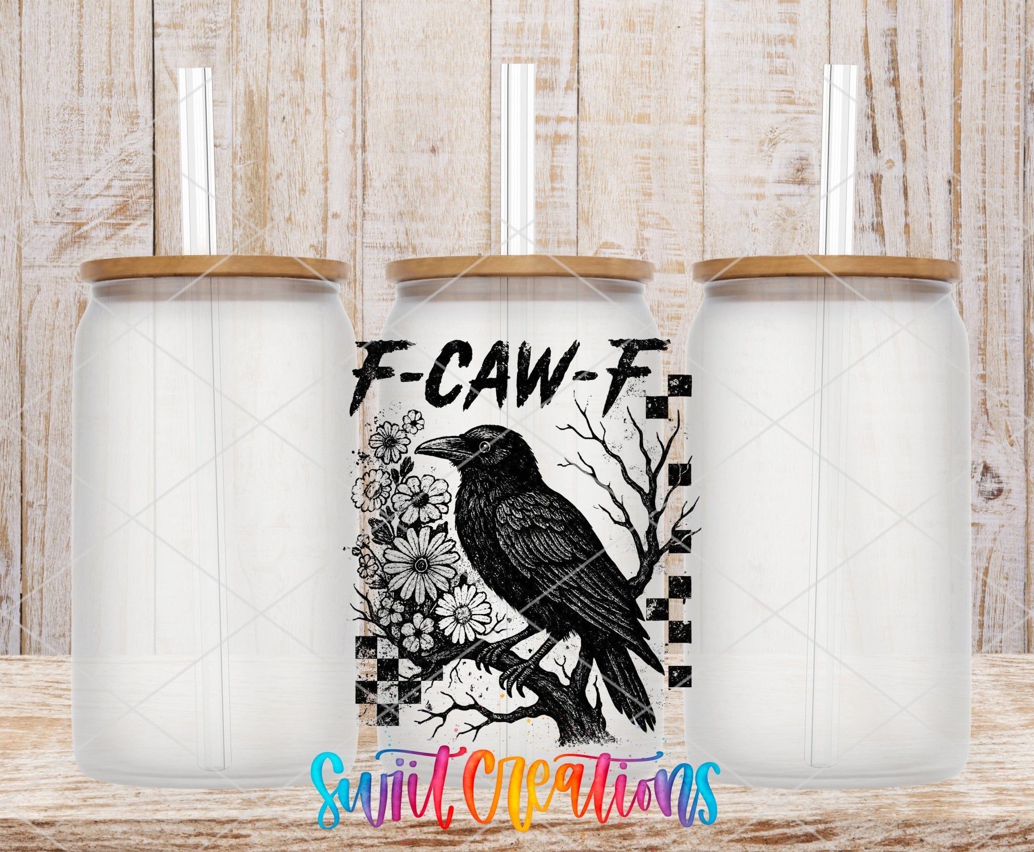 F-CAW-F Raven Gothic UV DTF transfer applied to a clear glass can set from Swiit Creations