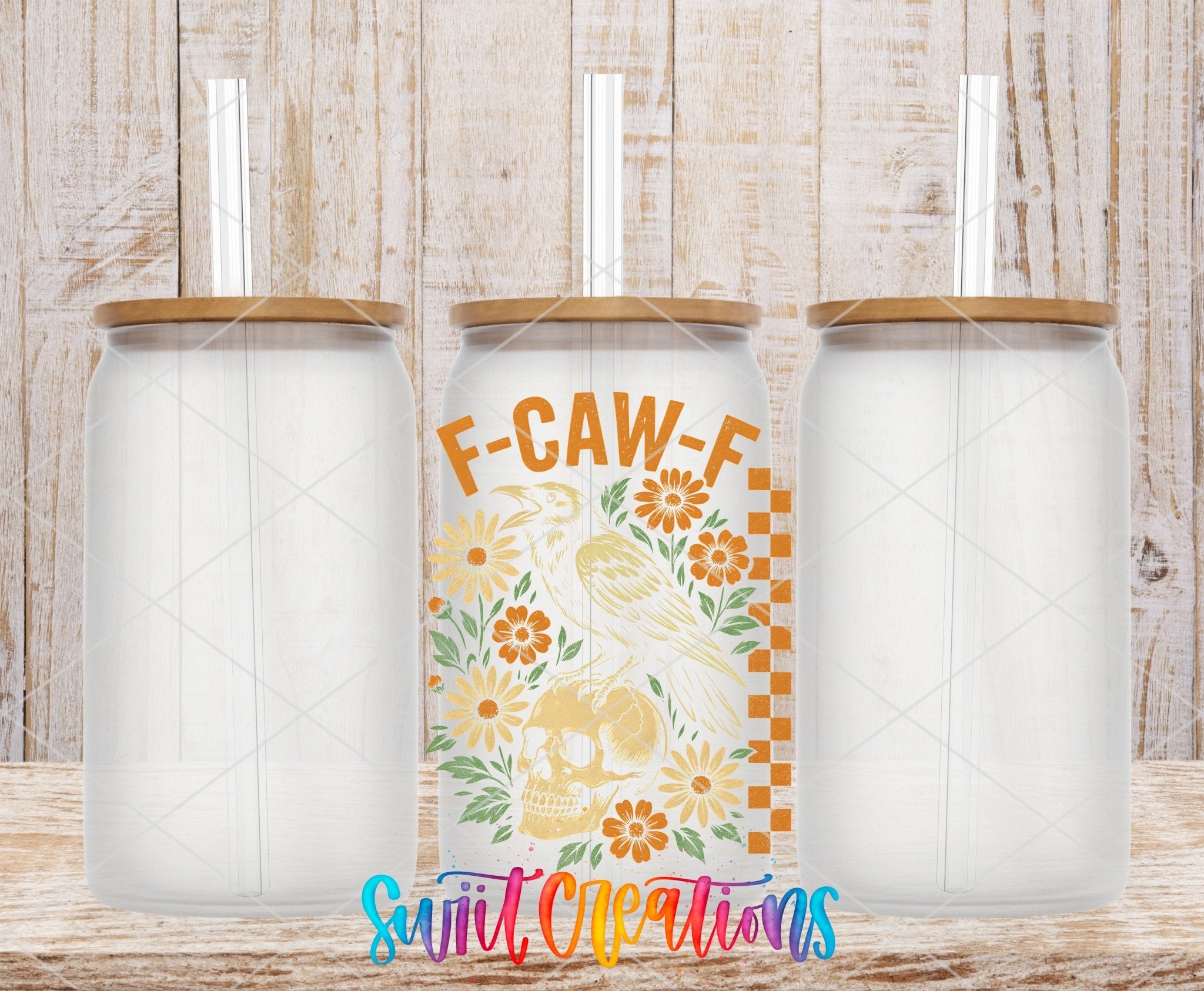 F Caw F Raven Skull Sassy Floral UV DTF transfer applied to a clear glass can set from Swiit Creations