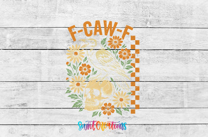 F-CAW-F raven, skull, and orange flowers UV DTF transfer artwork on a white wood background