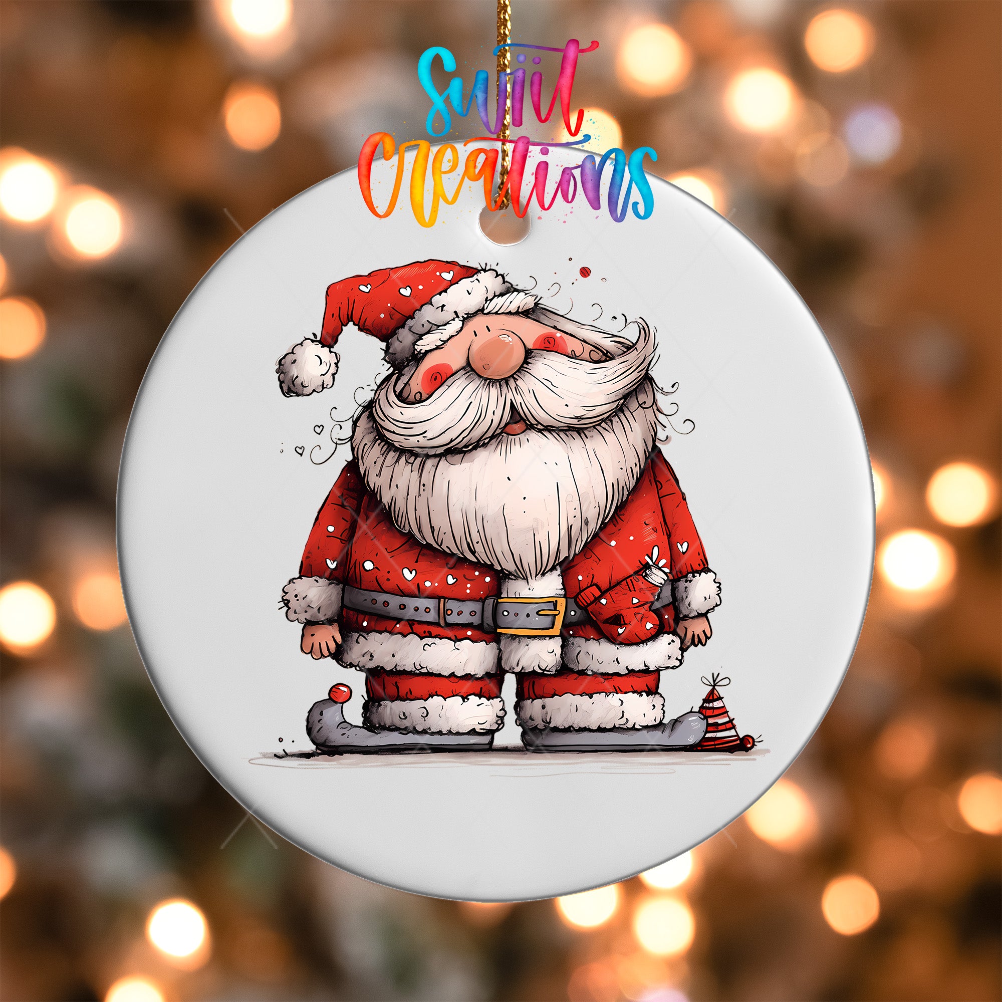 A white ornament featuring a cartoon illustration of Santa Claus wearing a red suit and hat, with a snowman decoration on his left foot.