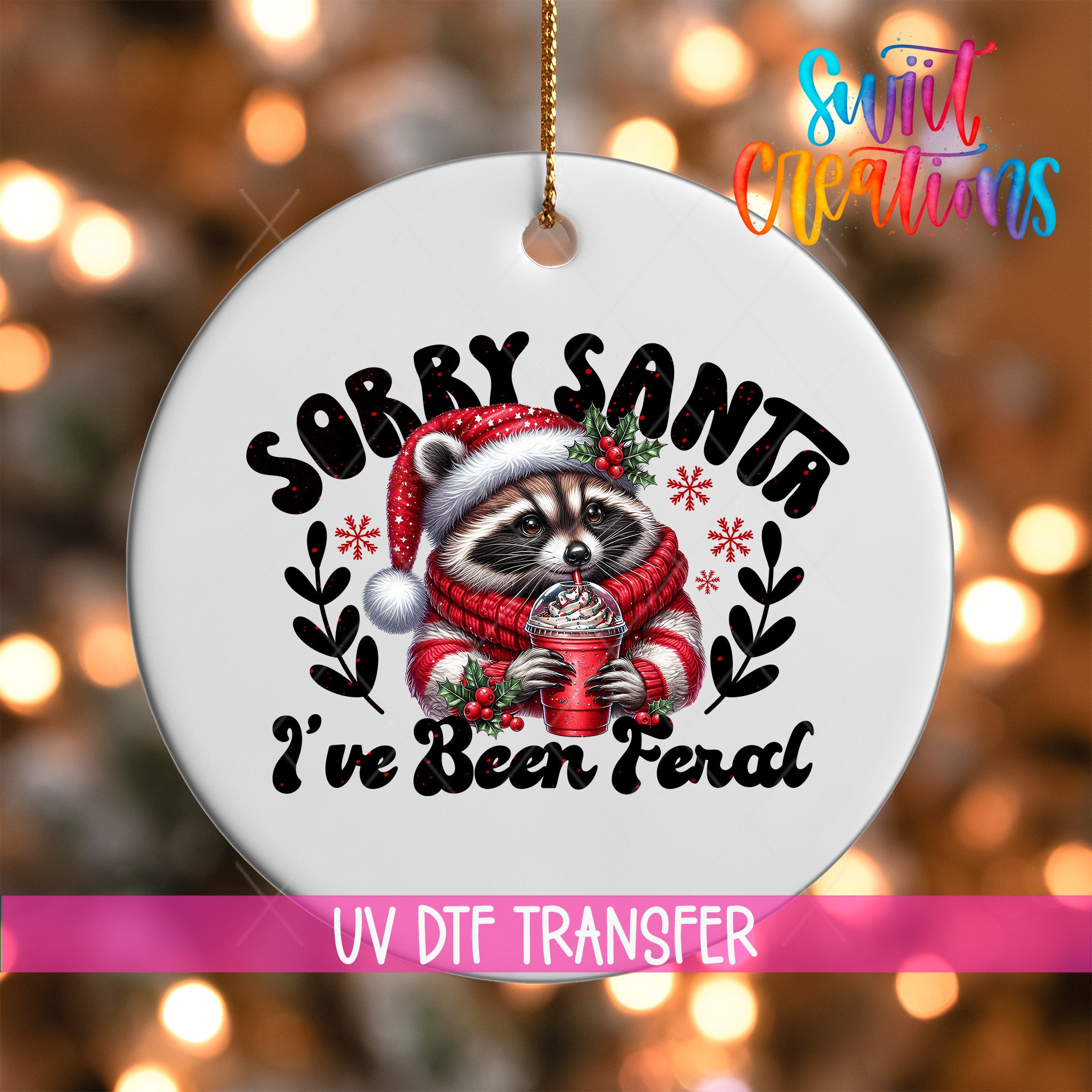 A white ornament with a raccoon wearing a Santa hat and scarf, holding a drink, and the text "Sorry Santa I've Been Feral" printed on it.