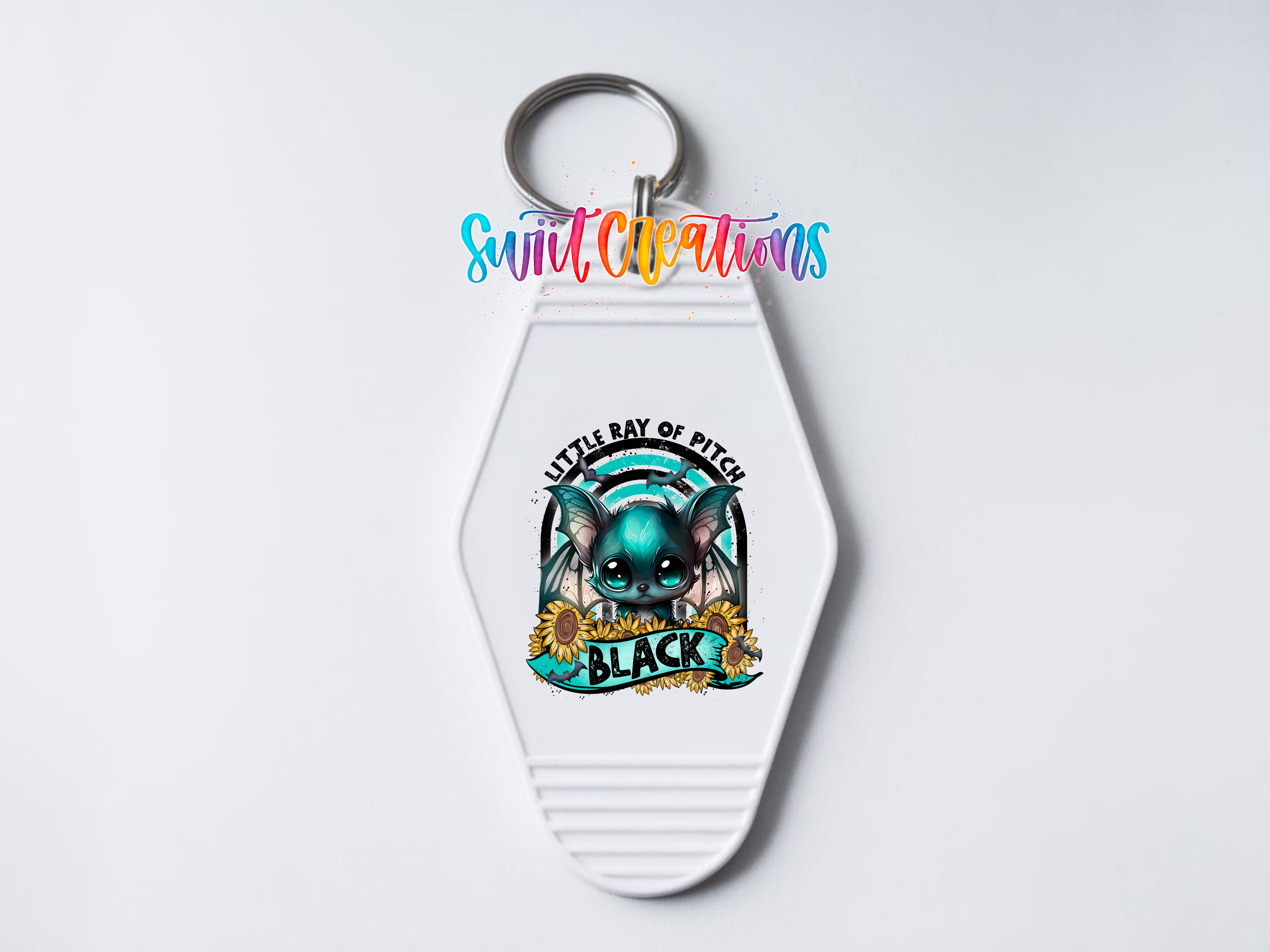 A keychain with a colorful design featuring a cartoon character and the text "Little Bay of Pitch" and "Black".