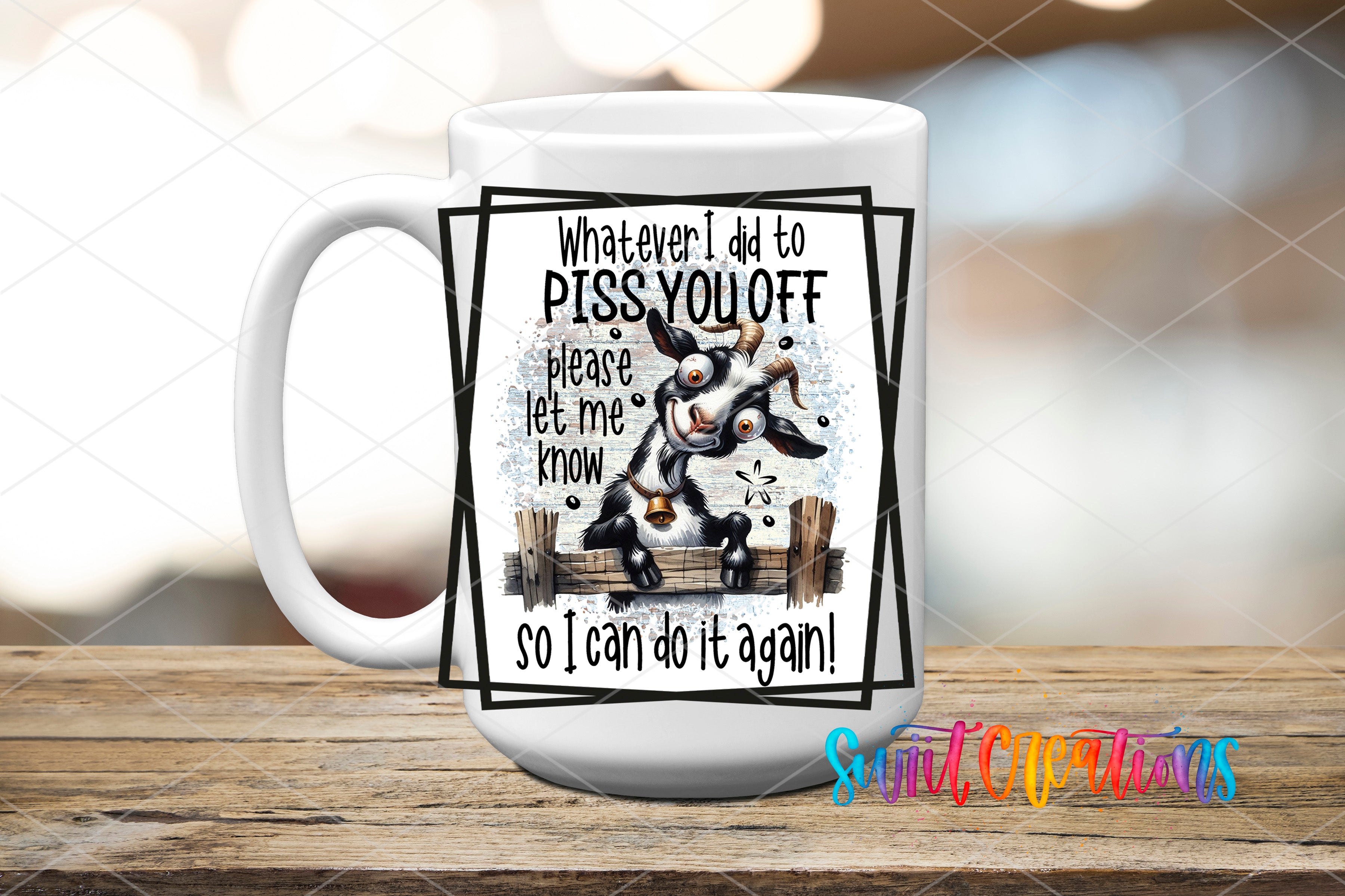 A white mug with a humorous text and an illustration of a goat on it, placed on a wooden surface.