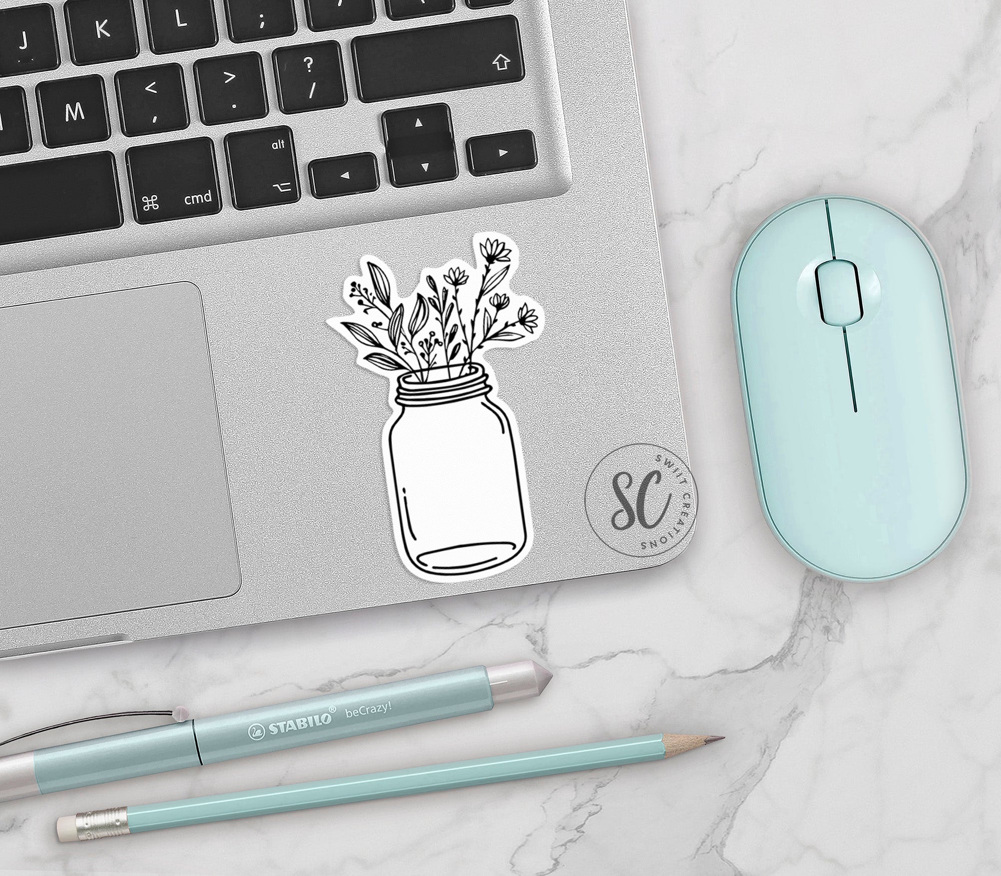 a laptop with a sticker of a mason jar with flowers
