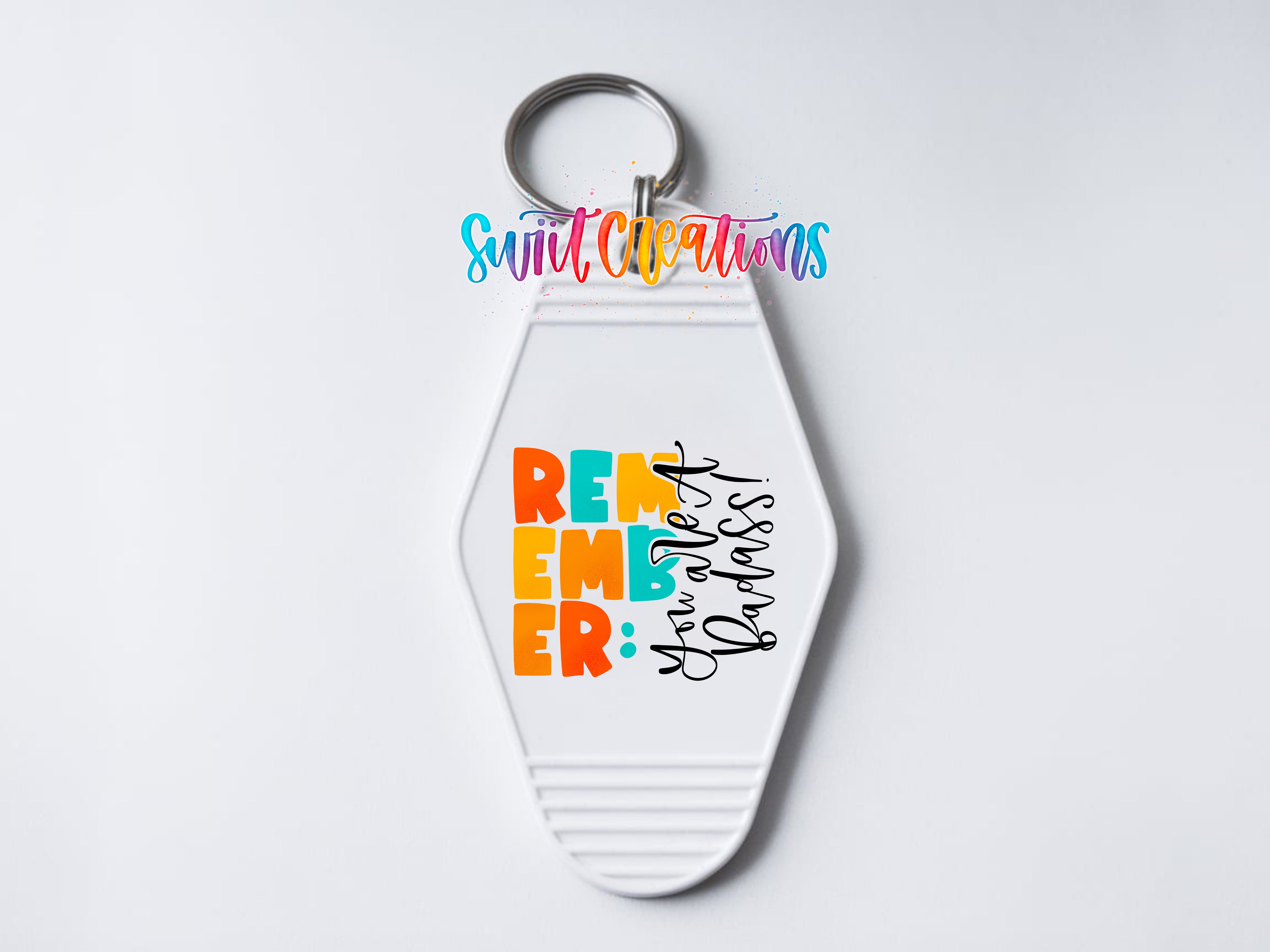 A keychain with a colorful design and text on it.