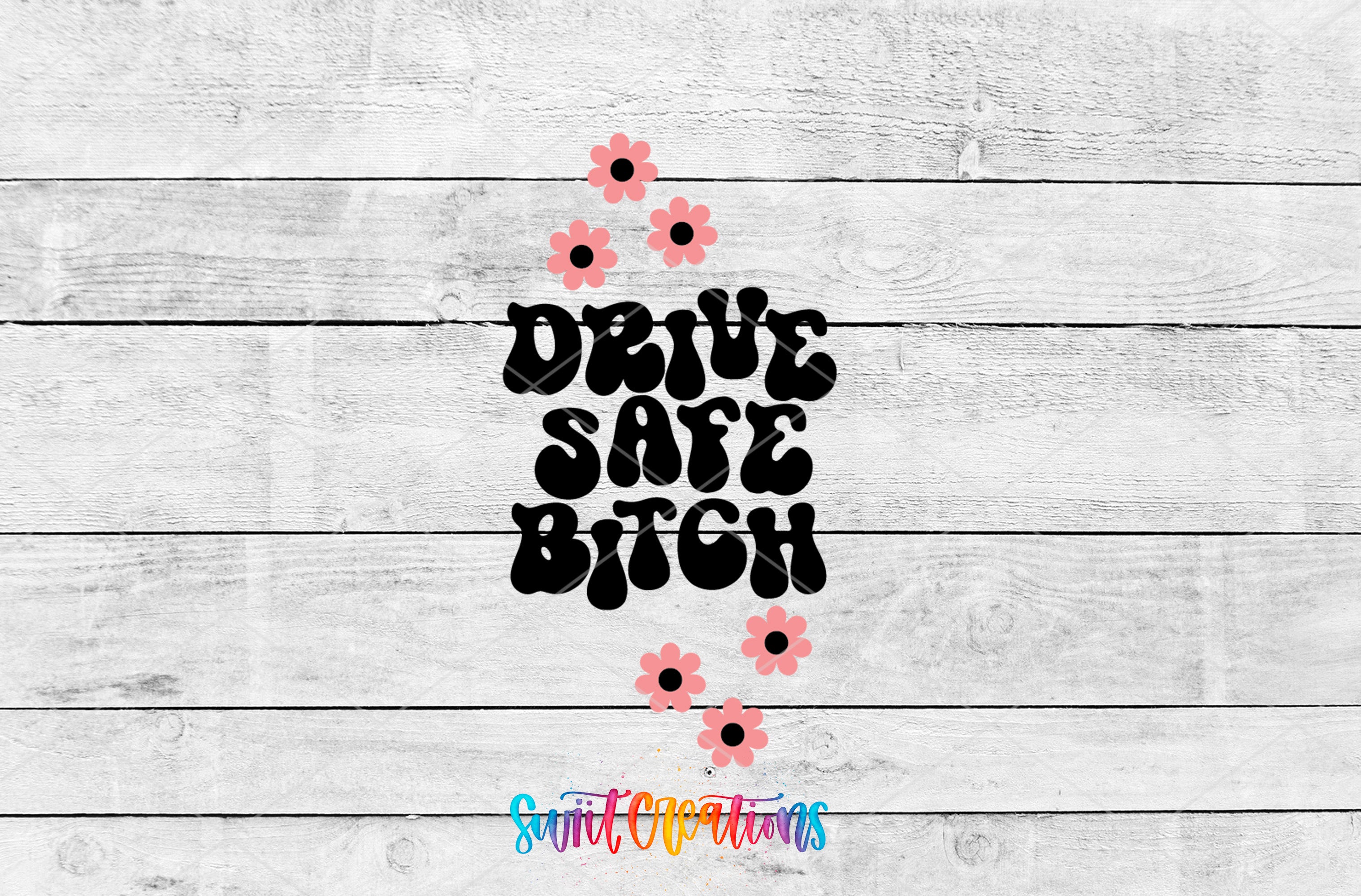 a wooden background with a stylized text that reads "DRIVE SAFE BITCH" in a playful, flowery font.