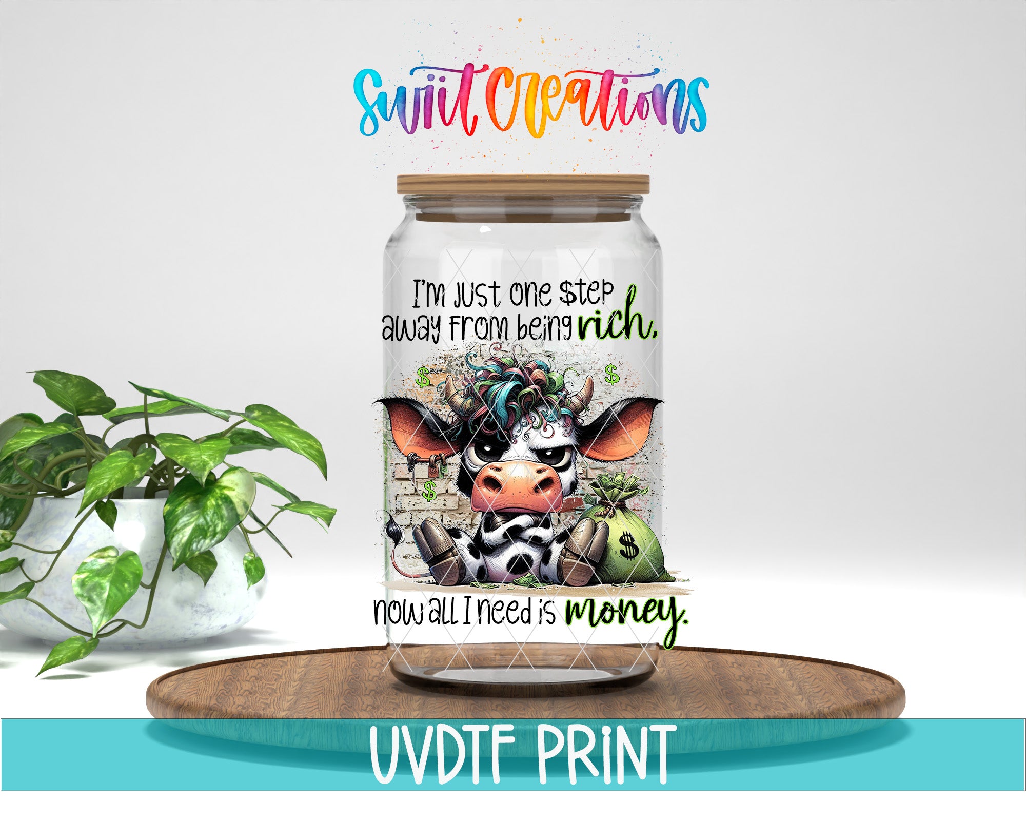 a jar with a cow design and text, placed on a wooden surface next to a potted plant.