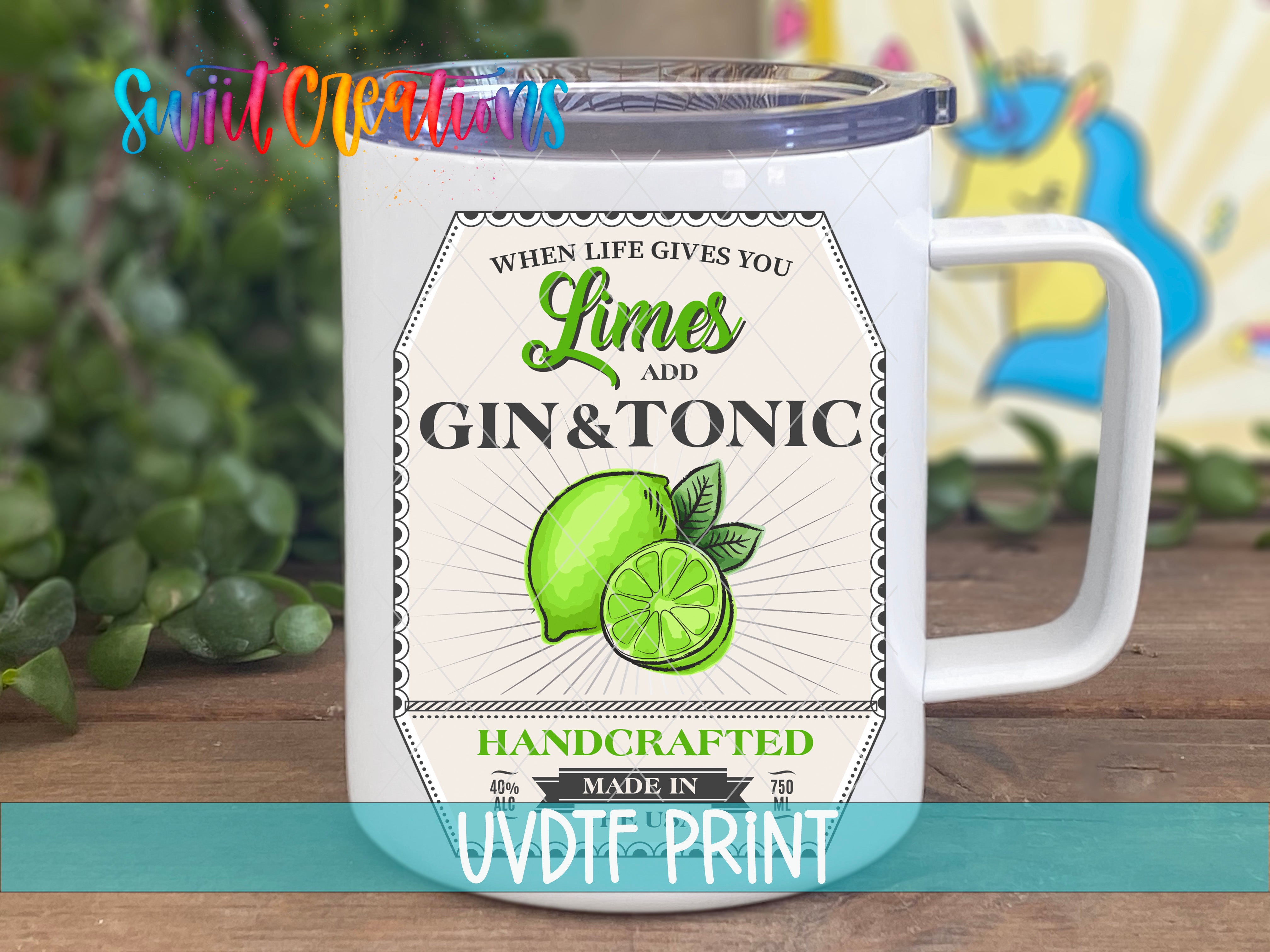 a white coffee mug with limes and gin and tonic on it