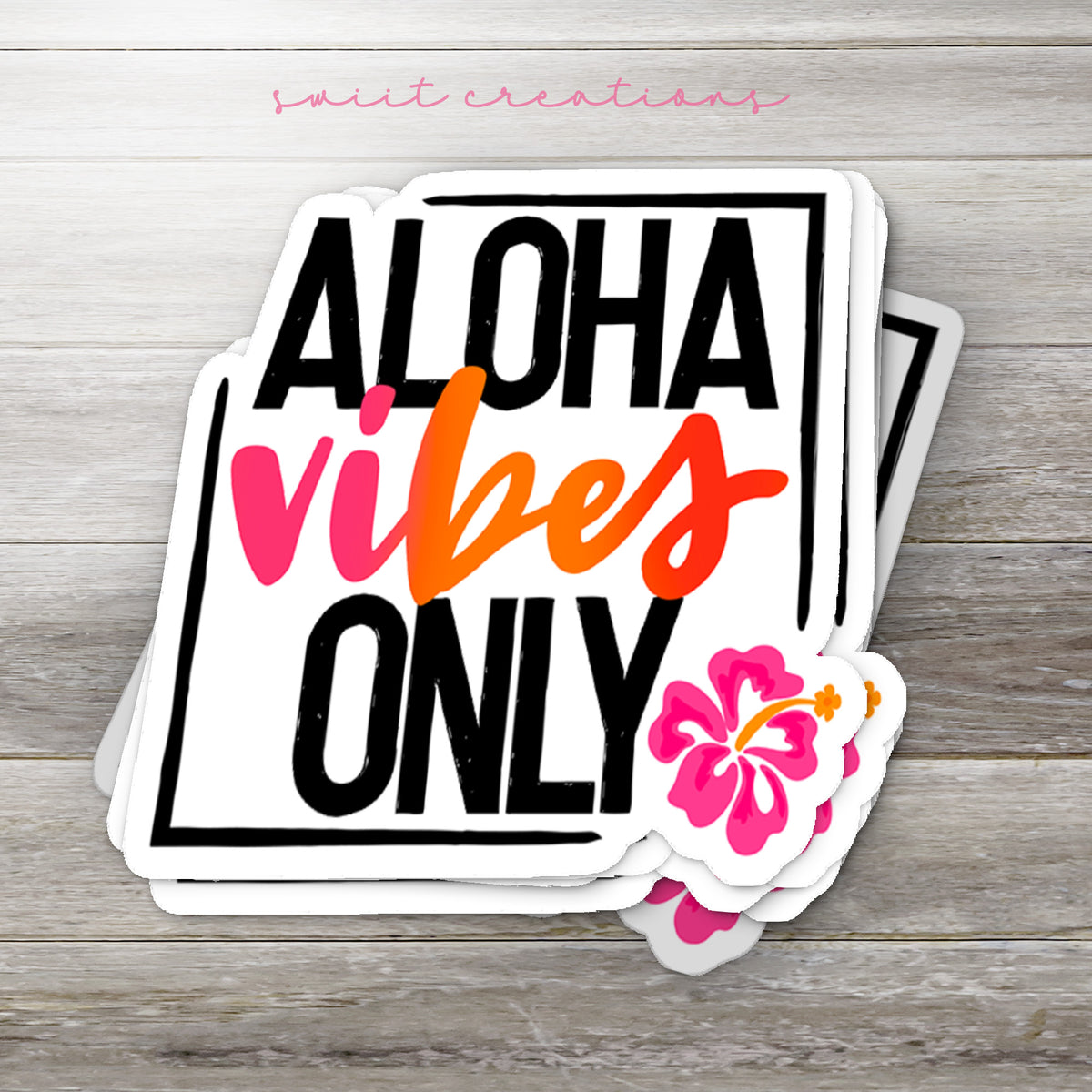 Stack of Aloha Vibes Only glossy stickers on a gray wood table