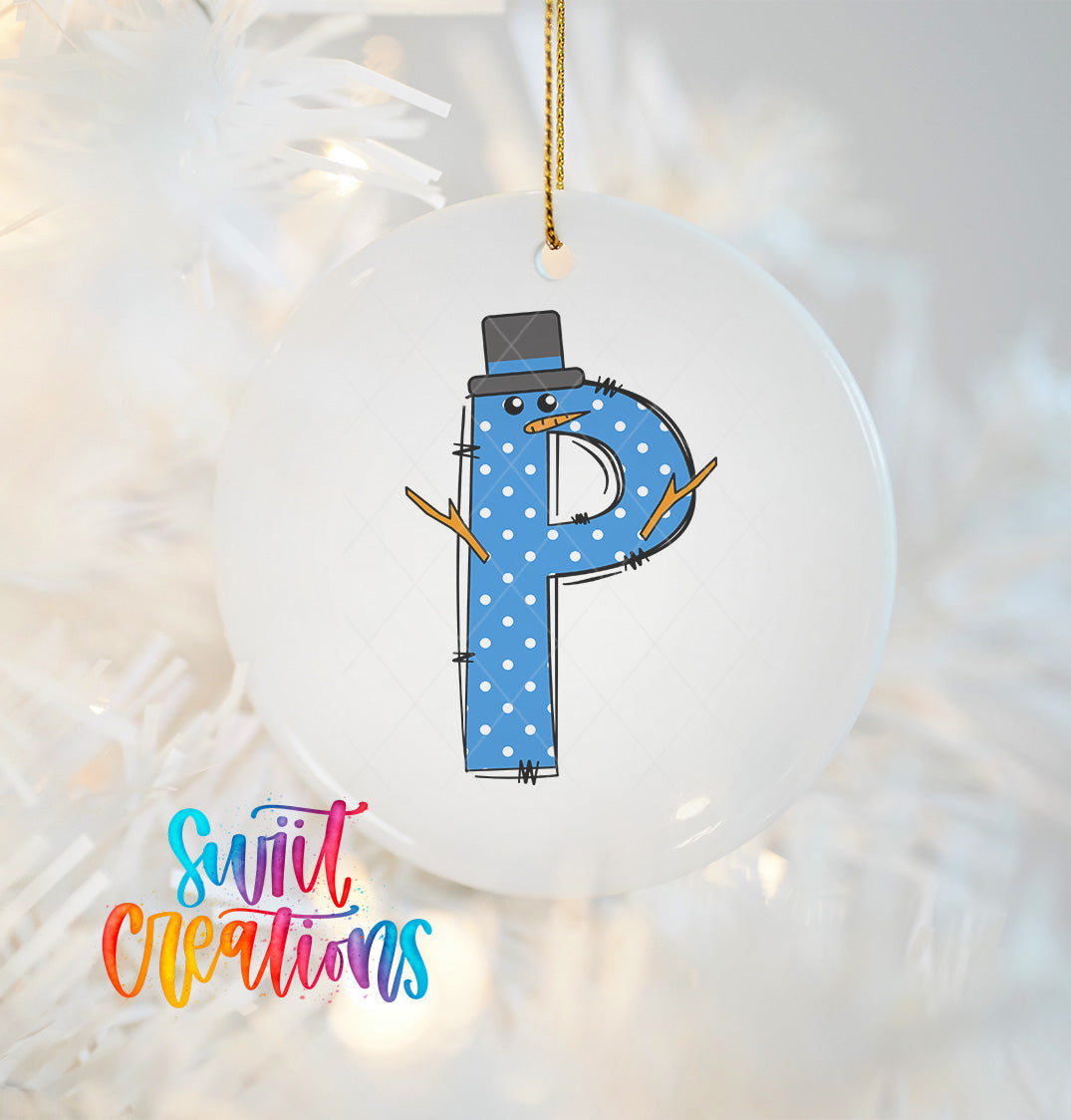 A white ornament with a blue letter "P" and a snowman design hanging on a Christmas tree.