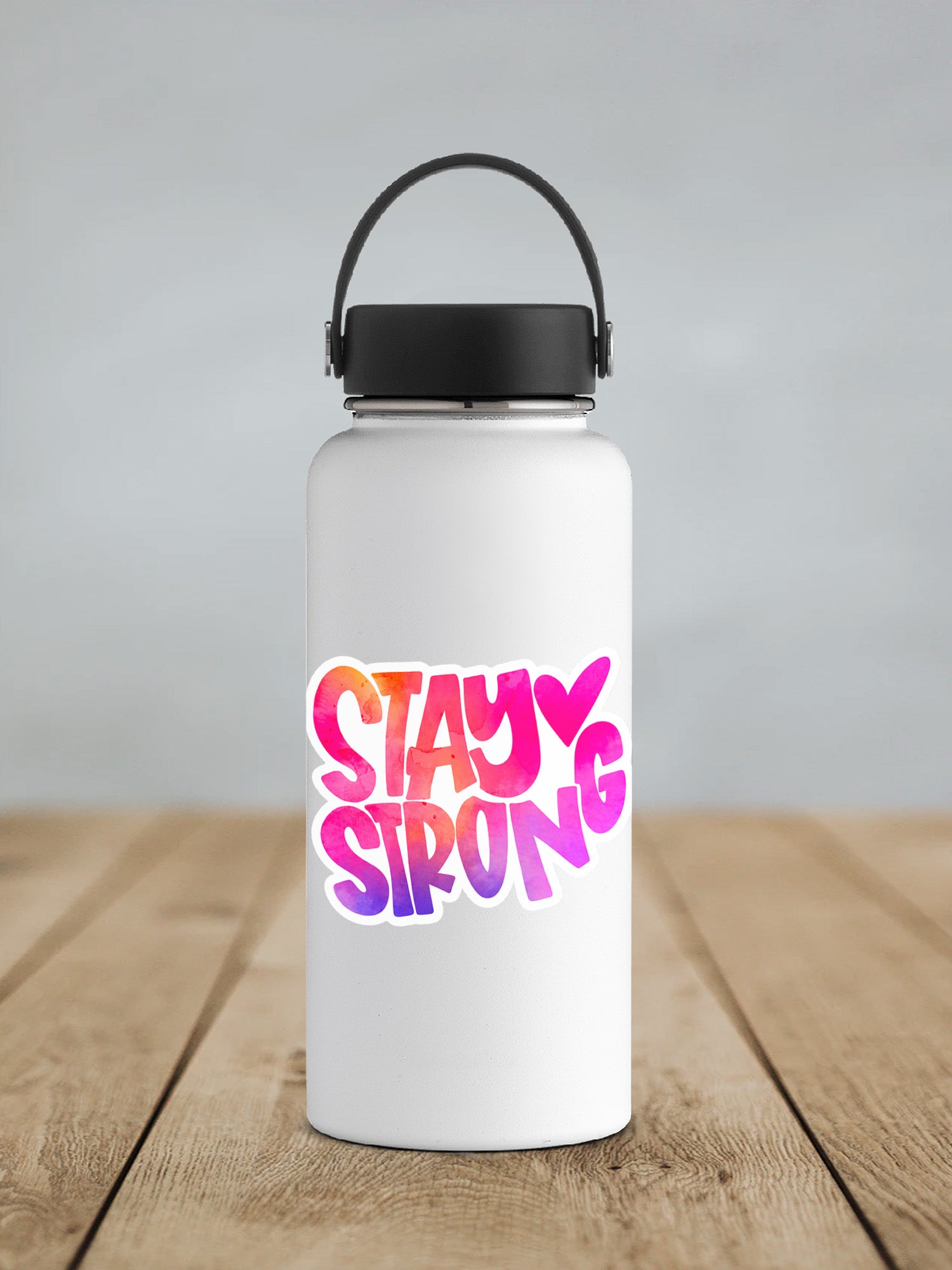 a white water bottle with the words stay strong on it