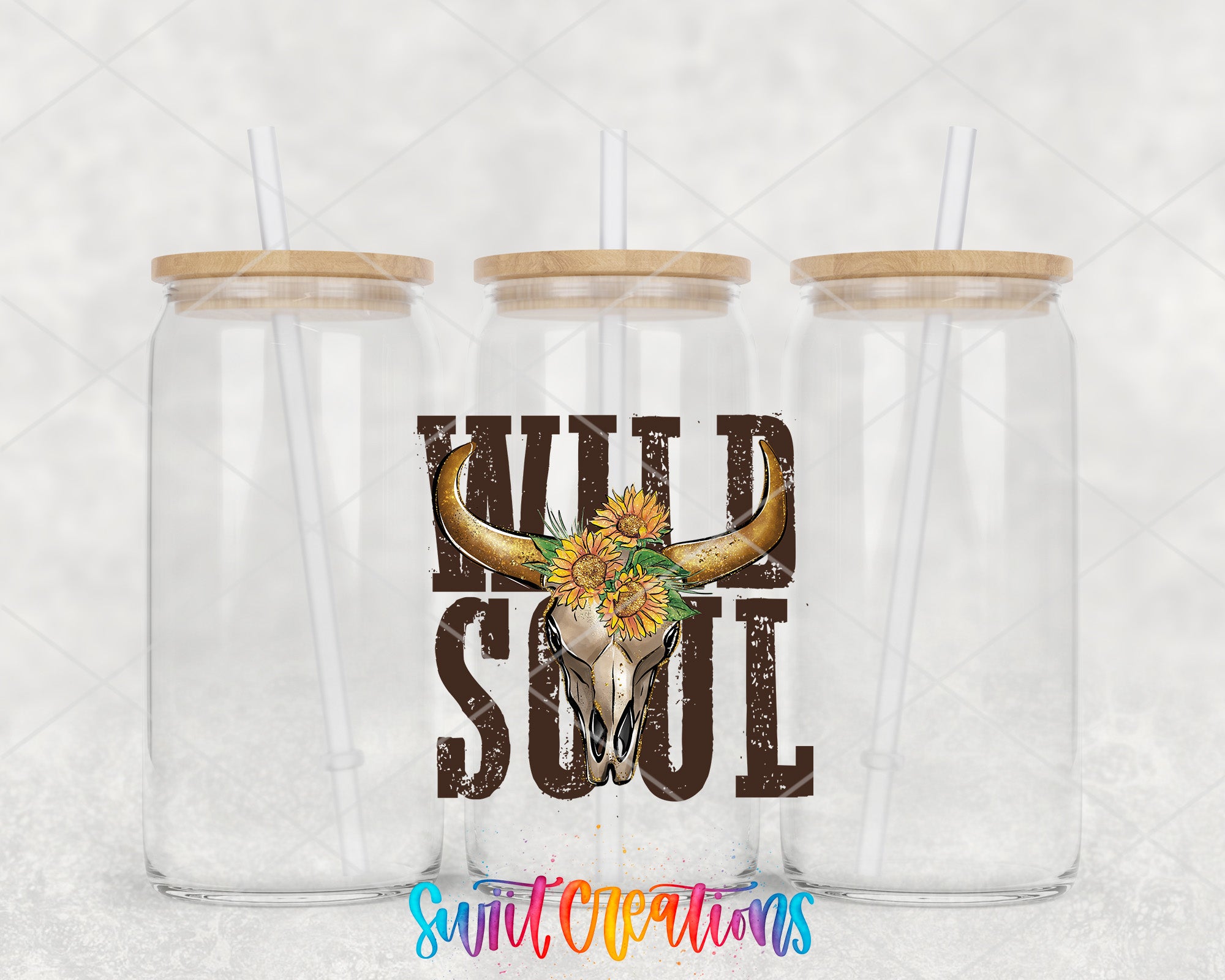 two clear tumblers with a cow skull and sunflowers on them