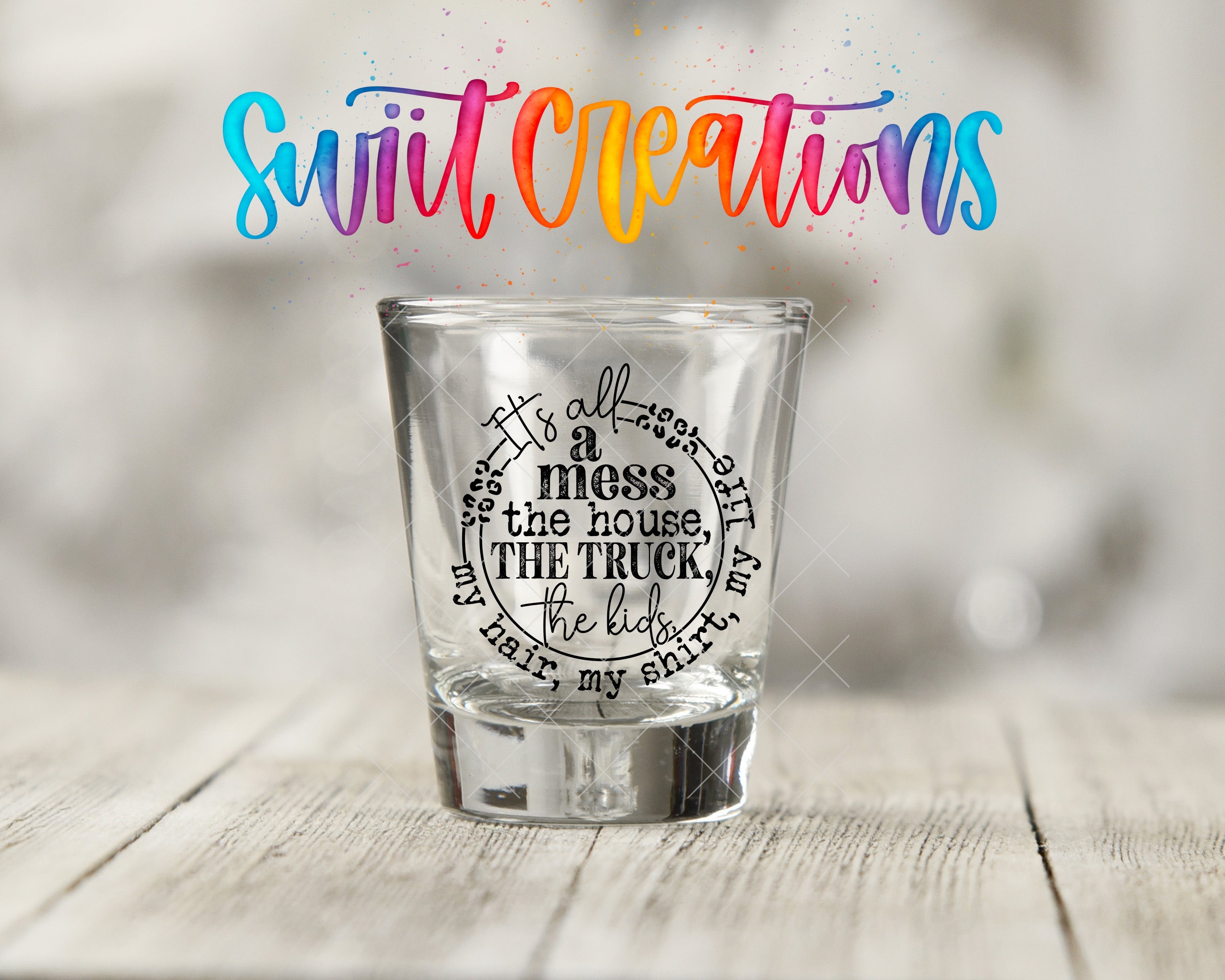 a shot glass sitting on top of a wooden table