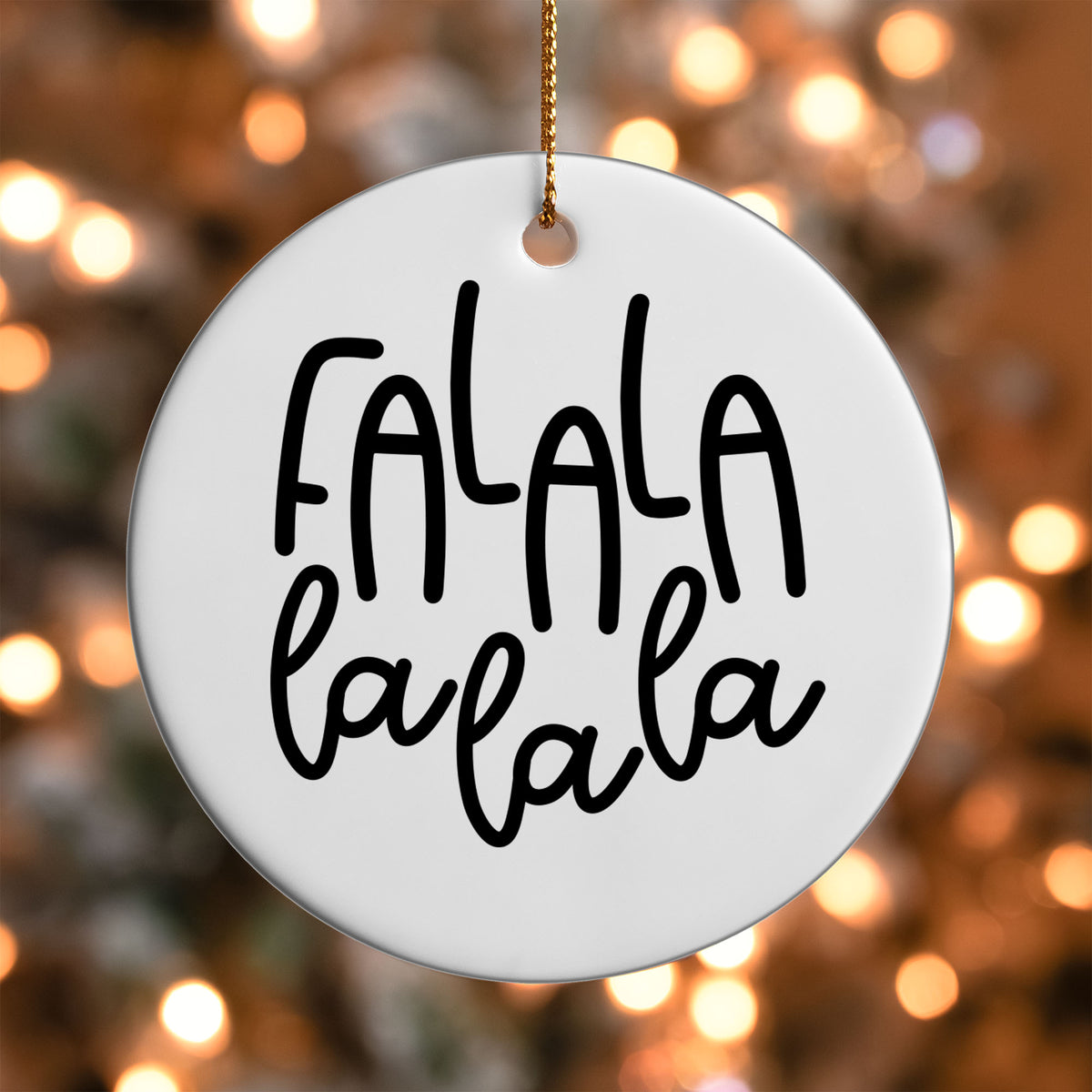 Fa La La La La ornament UV DTF transfer on a round white ornament with a bokeh light background