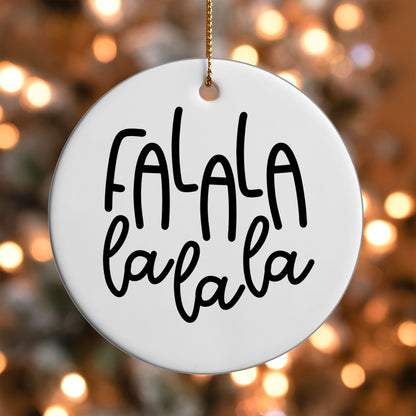 Fa La La La La ornament UV DTF transfer on a round white ornament with a bokeh light background