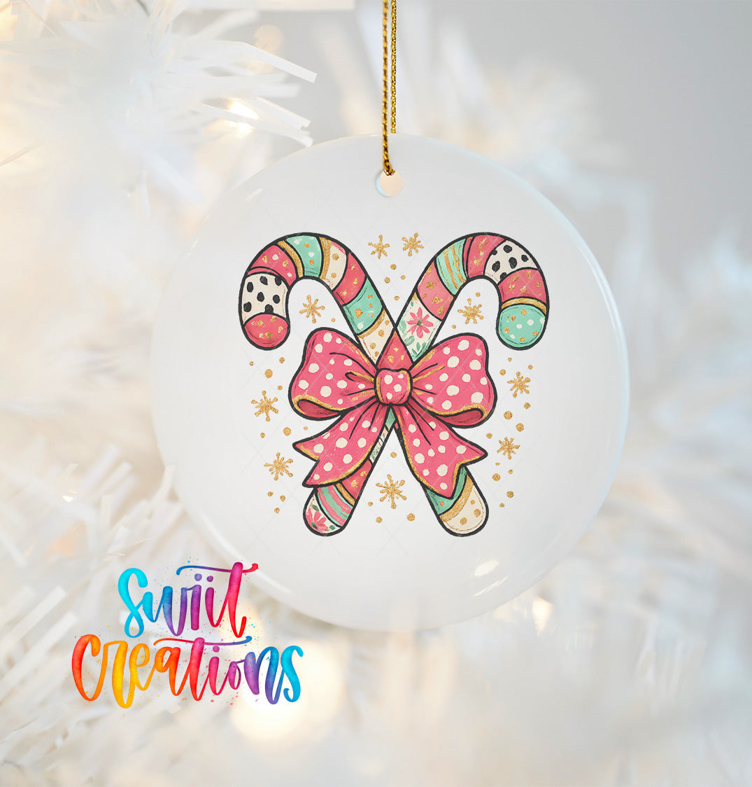 A white ornament with a colorful candy cane design and a pink bow, hanging on a white background.