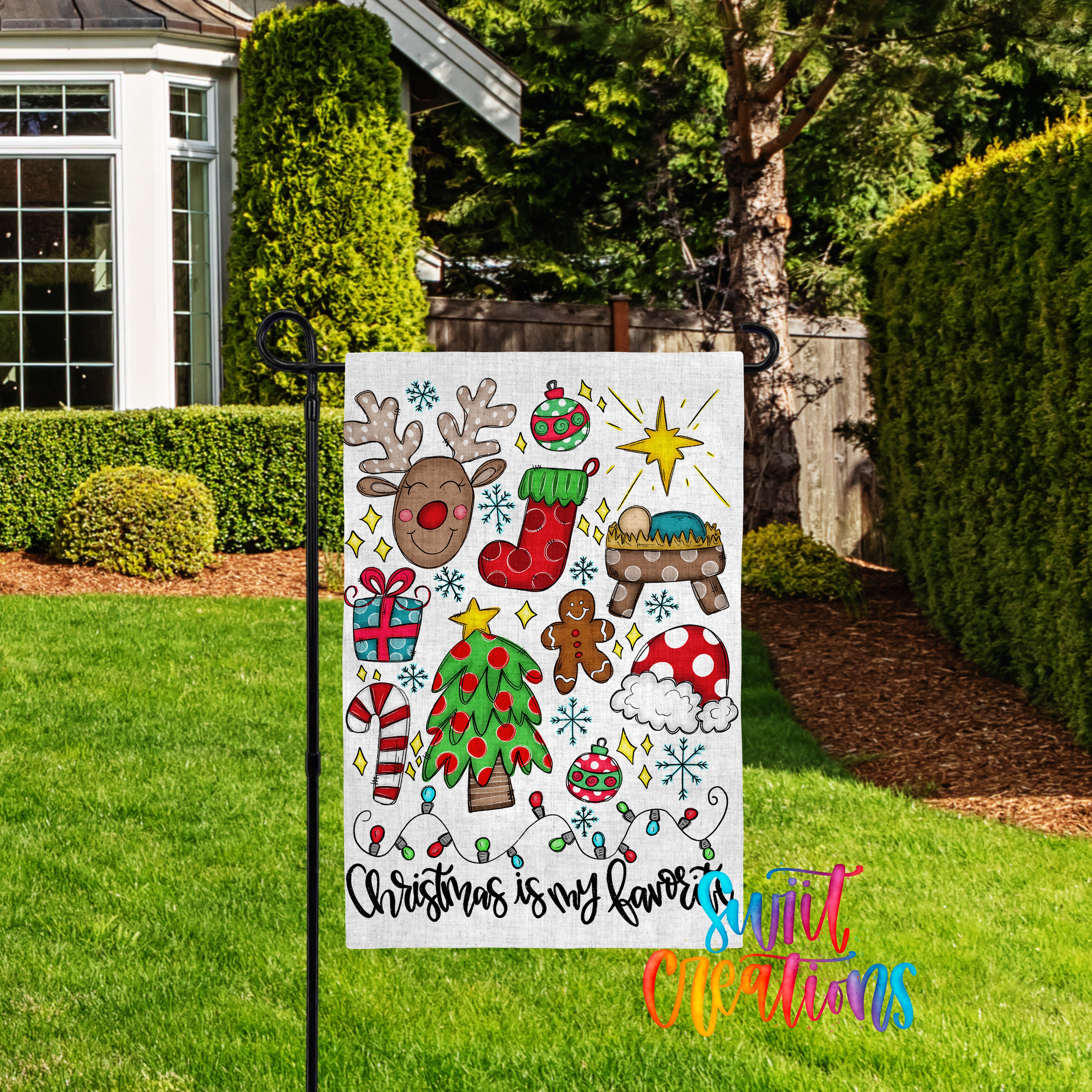 A colorful Christmas-themed garden sign featuring various holiday decorations such as reindeer, snowmen, and a nativity scene, with the text "Christmas is my favorite" displayed on it.