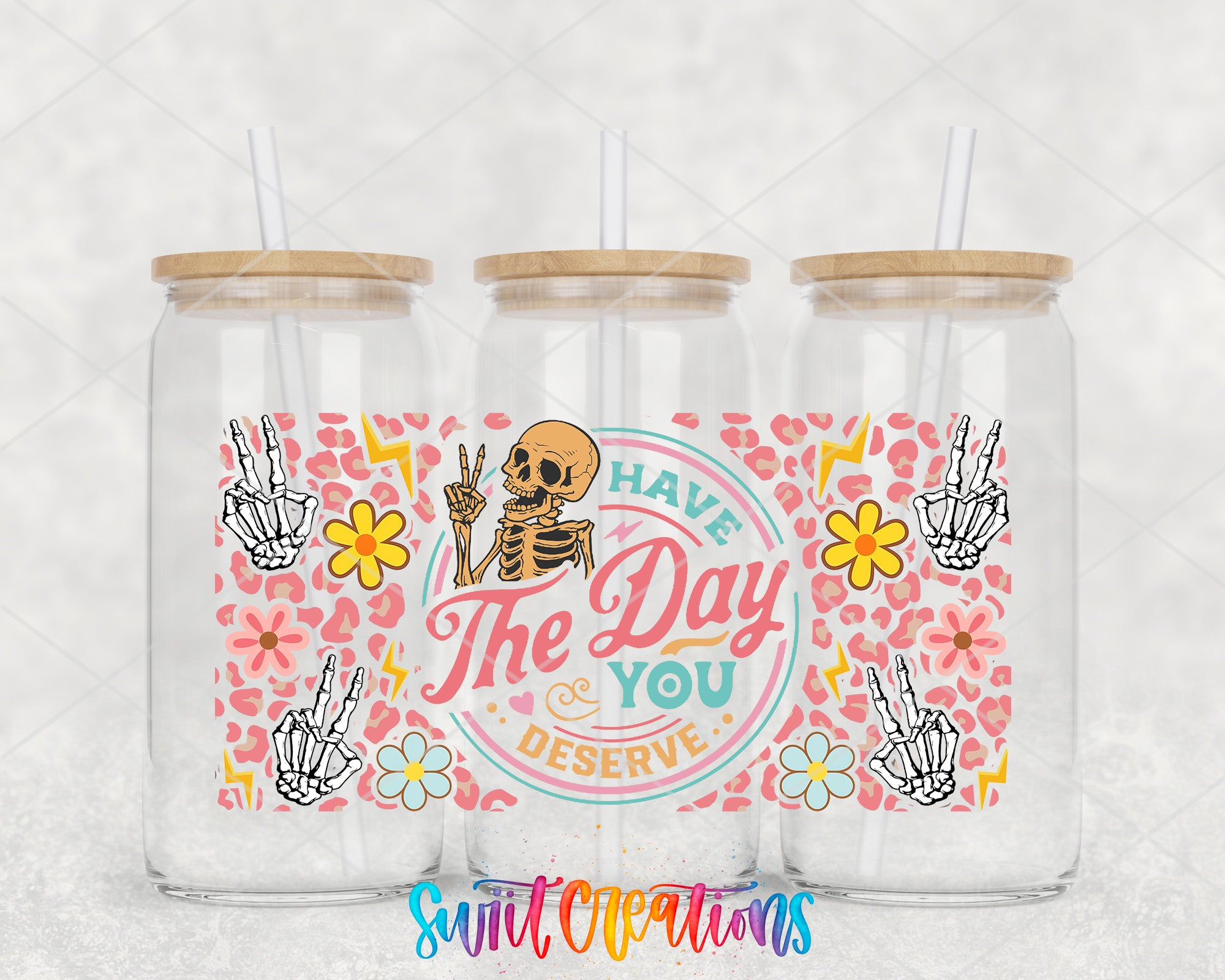 three glass jars with a colorful and whimsical design, including a skeleton, flowers, and the text "The Day You Deserve".
