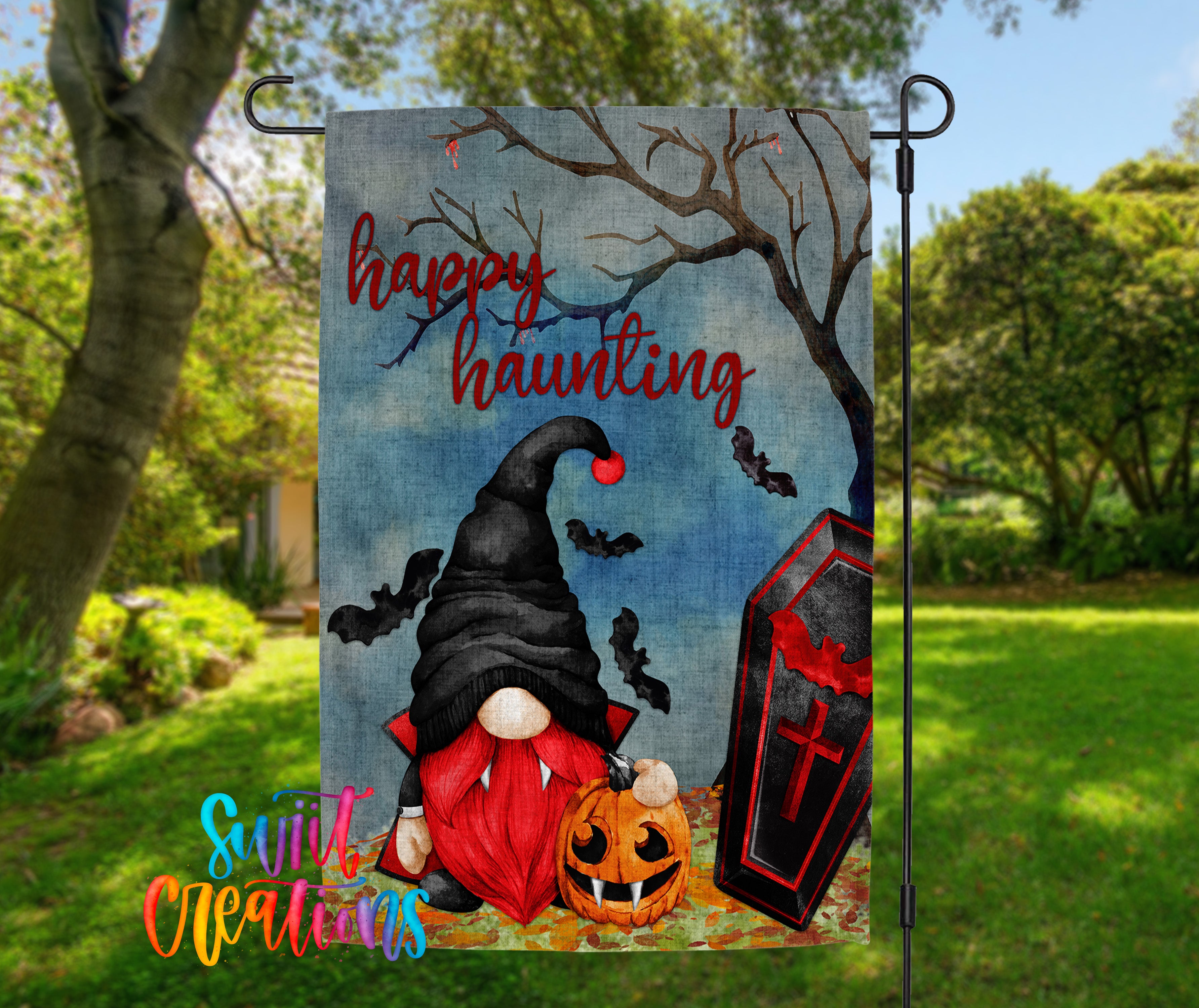 A Halloween-themed garden flag featuring a gnome, a pumpkin, a casket, and bats against a spooky background.