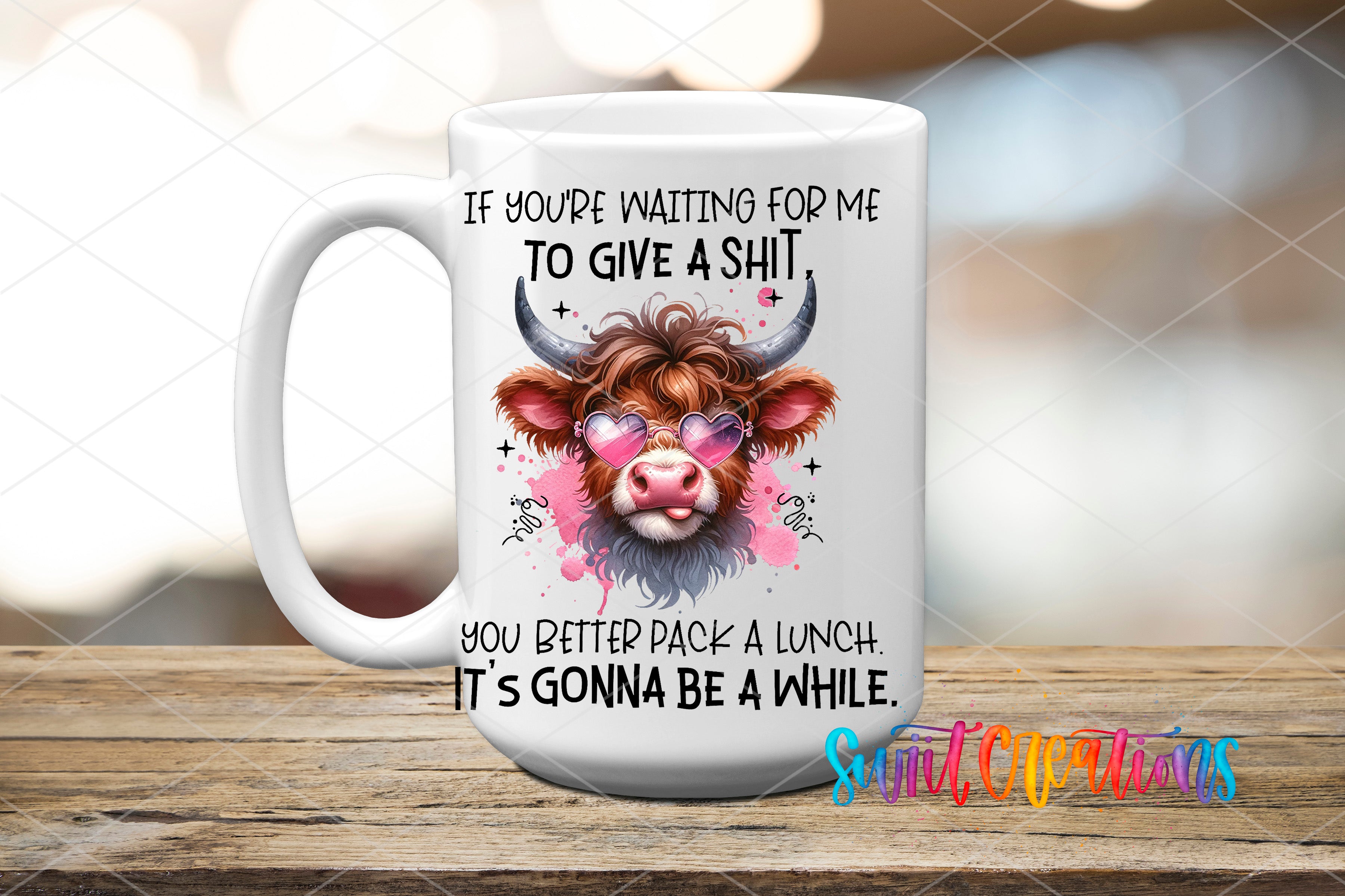 A white ceramic mug with a humorous text and an illustration of a cow's head wearing sunglasses.