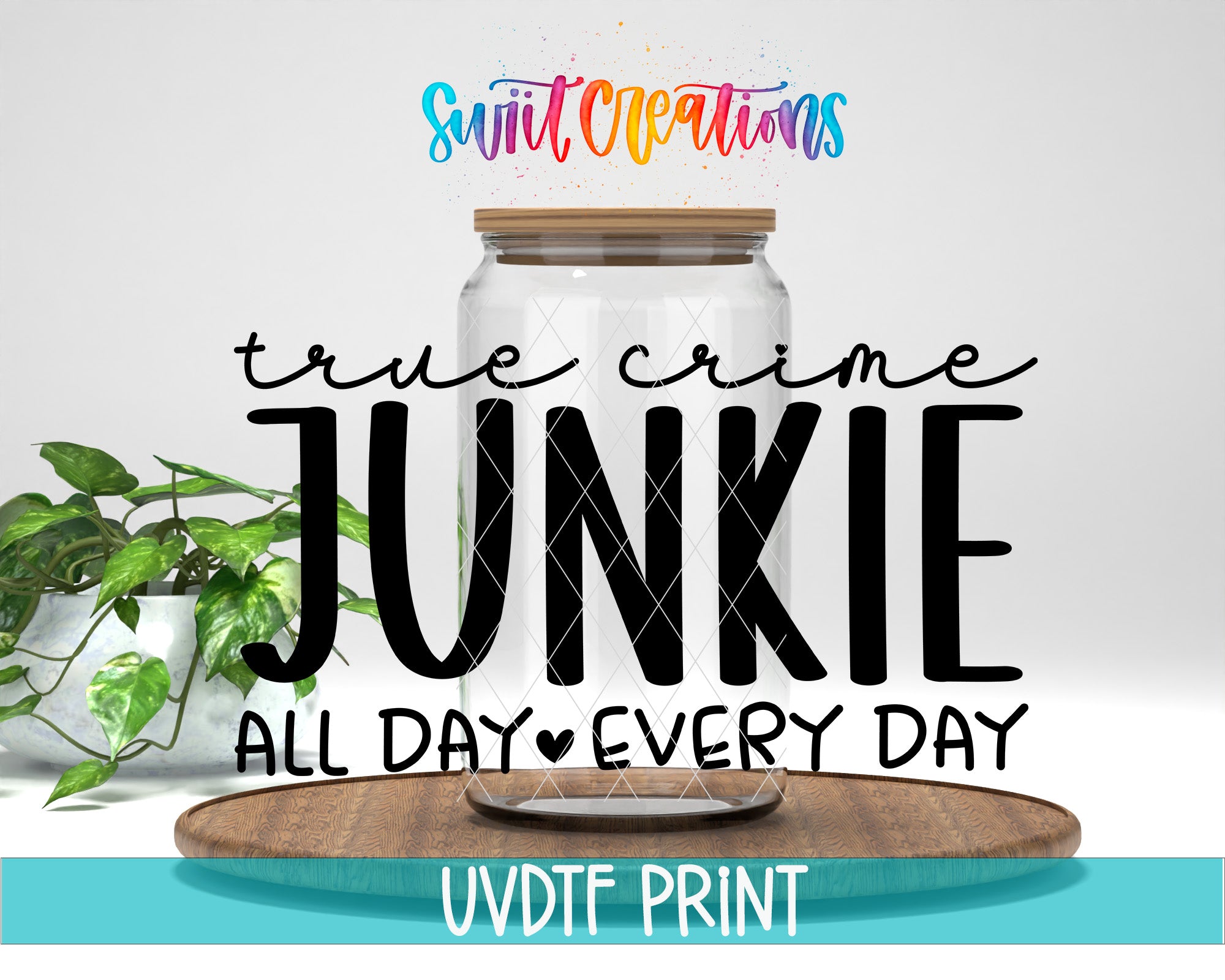 a large text overlay that reads "True crime JUNKIE ALL DAY EVERY DAY" with a colorful, artistic design above it. The text is in a playful, creative font and is placed over a wooden surface. There is also a plant in the background, adding a natural element to the overall composition.