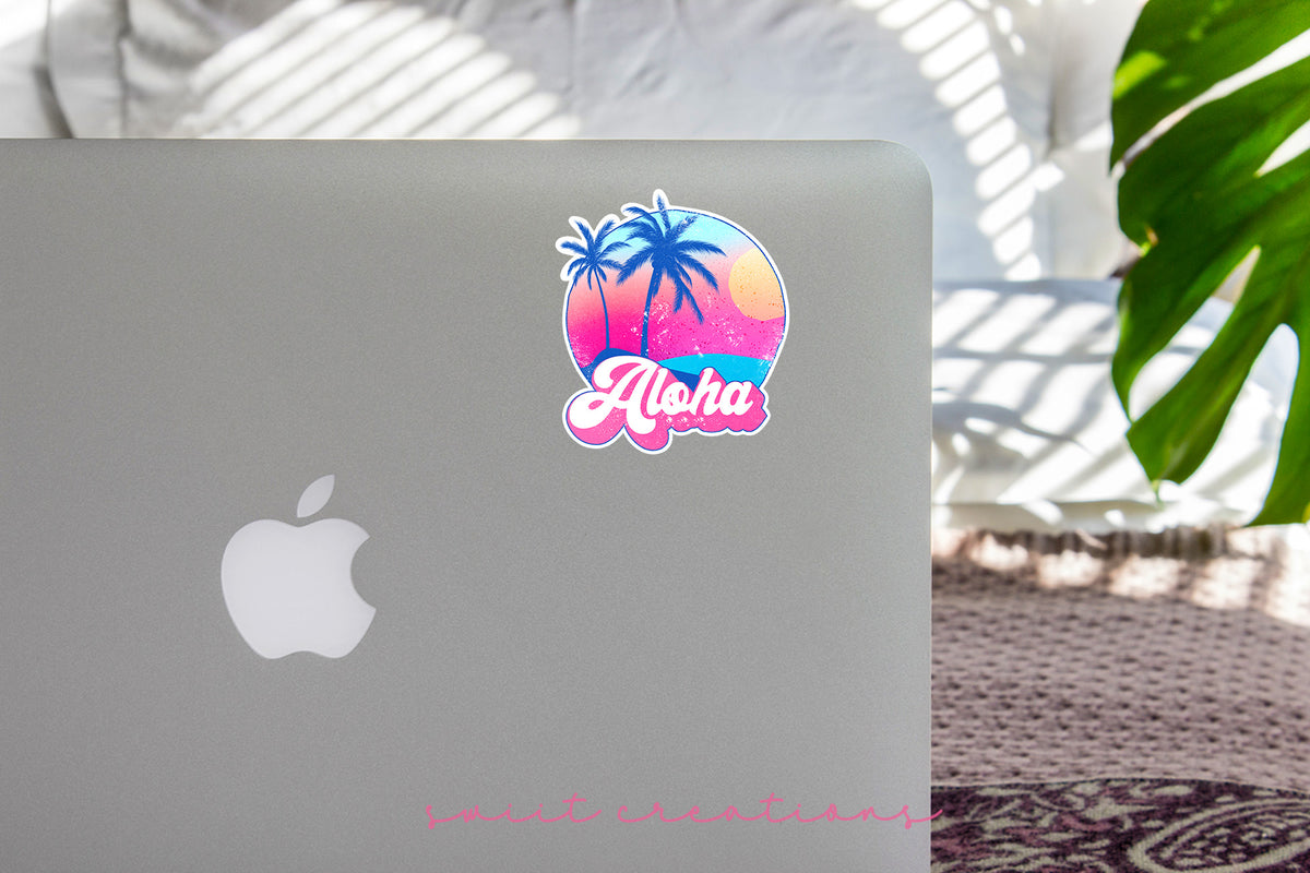 Aloha sticker on the lid of a silver laptop